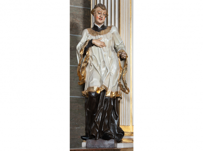 Rzeźba świętego Alojzego Gonzagi w kościele w Więcławicach Starych. Święty ubrany jest w sutannę i komżę.
