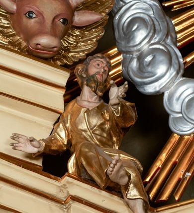 Zdjęcie nr 49: Przyścienny architektoniczny ołtarz jednoosiowy i jednokondygnacjowy, ze zwieńczeniem. Ołtarz jest murowany, w formie prostopadłościennej, skrzyni z portatylem i drewnianym antepedium. Nastawa ołtarzowa jest osadzona na dwóch flankujących mensę wysokich, ukośnych cokołach. Część środkową retabulum ujmuje para skośnie ustawionych filarów, pilastrów i kolumn o korynckich kapitelach wspierających subtelnie wyłamujące się ponad nimi, przerwane w partii architrawu i fryzu belkowanie. Zwieńczenie jest w formie przerwanego, półkolistego skośnie ustawionego przyczółka. Boki cokołu retabulum zdobi motyw wazonów. Pole ujętego profilowaną, złoconą ramą antepedium wypełniają trzy okrągłe medaliony, środkowy z monogramem imienia Jezus, w dwóch bocznych litery A i Ω, a w narożach motywy akantu. Część środkowa retabulum jest zaaranżowana w formie wnęki w kształcie stojącego prostokąta zamkniętego nadwieszonym łukiem półkolistym, ujętej profilowaną, złocona ramą, której dłuższe boki zdobią różane gałązki z kwiatami. Pośrodku belkowania znajduje się fantazyjny, rocaille'owy kartusz. Boki zwieńczenia zdobią figury czterech ewangelistów wraz z ich symbolami od prawej: św. Marek z lwem, św. Jan z orłem, św. Mateusz (brak), św. Łukasz z wołem. Pośrodku zwieńczenia znajduje się promienista gloria o alternowanych promieniach, z wieńcem srebrzonych obłoków oraz z trójkątem z okiem Opatrzności Bożej w centrum. Po bokach retabulum umieszczono figury św. Wojciecha po prawej i św. Stanisława po lewej stronie. 
Tabernakulum jest w formie niewielkiej, prostopadłościennej skrzynki obitej miedzianą blachą z trybowanym chryzmonem na drzwiczkach i mniejszymi scenami figuralnymi w obramowaniu.

 Struktura ołtarza utrzymana jest w kolorze kremowym, detal architektoniczny i ornamentyka są złocone.   

