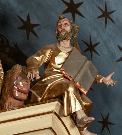 Zdjęcie nr 5: Przyścienny architektoniczny ołtarz jednoosiowy i jednokondygnacjowy, ze zwieńczeniem. Ołtarz jest murowany, w formie prostopadłościennej, skrzyni z portatylem i drewnianym antepedium. Nastawa ołtarzowa jest osadzona na dwóch flankujących mensę wysokich, ukośnych cokołach. Część środkową retabulum ujmuje para skośnie ustawionych filarów, pilastrów i kolumn o korynckich kapitelach wspierających subtelnie wyłamujące się ponad nimi, przerwane w partii architrawu i fryzu belkowanie. Zwieńczenie jest w formie przerwanego, półkolistego skośnie ustawionego przyczółka. Boki cokołu retabulum zdobi motyw wazonów. Pole ujętego profilowaną, złoconą ramą antepedium wypełniają trzy okrągłe medaliony, środkowy z monogramem imienia Jezus, w dwóch bocznych litery A i Ω, a w narożach motywy akantu. Część środkowa retabulum jest zaaranżowana w formie wnęki w kształcie stojącego prostokąta zamkniętego nadwieszonym łukiem półkolistym, ujętej profilowaną, złocona ramą, której dłuższe boki zdobią różane gałązki z kwiatami. Pośrodku belkowania znajduje się fantazyjny, rocaille&#039;owy kartusz. Boki zwieńczenia zdobią figury czterech ewangelistów wraz z ich symbolami od prawej: św. Marek z lwem, św. Jan z orłem, św. Mateusz (brak), św. Łukasz z wołem. Pośrodku zwieńczenia znajduje się promienista gloria o alternowanych promieniach, z wieńcem srebrzonych obłoków oraz z trójkątem z okiem Opatrzności Bożej w centrum. Po bokach retabulum umieszczono figury św. Wojciecha po prawej i św. Stanisława po lewej stronie. 
Tabernakulum jest w formie niewielkiej, prostopadłościennej skrzynki obitej miedzianą blachą z trybowanym chryzmonem na drzwiczkach i mniejszymi scenami figuralnymi w obramowaniu.

 Struktura ołtarza utrzymana jest w kolorze kremowym, detal architektoniczny i ornamentyka są złocone.   

