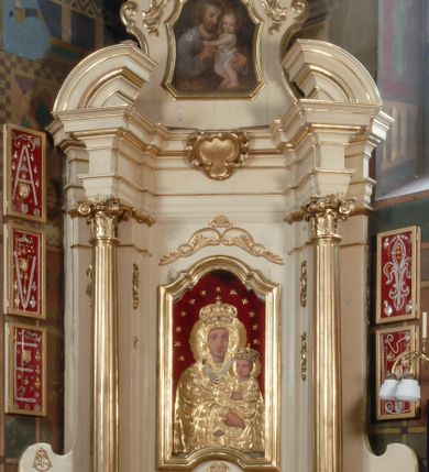 Zdjęcie nr 7: Ołtarz przyścienny, narożny, usytuowany po prawej stronie, w pierwszym od prezbiterium przęśle nawy, przy ścianie tęczowej. Architektoniczny, jednokondygnacyjny ze zwieńczeniem. Mensa murowana, prostopadłościenna, w typie skrzyniowym, z relikwiami nieznanego z imienia jednego ze świętych męczenników. Antepedium z blachy w drewnianej ramie, z monogramem imienia Jezus w centrum. Niewielkie, drewniane tabernakulum architektoniczne, na cokole. Jednoskrzydłowe drzwiczki zdobione płaskorzeźbionym kielichem z hostią, flankowane pilastrami o trzonach spływających wolutowo, podtrzymujących wyłamany gzyms. Nastawa ołtarzowa wsparta na flankujących mensę wysokich, dwudzielnych postumentach, dekorowanych złoconymi płycinami zdobionymi rocaille&#039;em. Części boczne na całej wysokości ustawione ukośnie w stosunku do osi środkowej ołtarza. Wysunięte przed zdwojone pilastry z trzonami dekorowanymi rocaille&#039;ami, kolumny o kanelowanych na całej wysokości, złoconych trzonach i kompozytowych kapitelach, dźwigają bogato profilowane, gierowane, pełne belkowanie, wyłamane na osi podpór. Wieńczy je przerwany, półkolisty przyczółek. W polu nastawy złocona, profilowana rama o kształcie stojącego, podciętego półkoliście u podstawy prostokąta zamkniętego łukiem wklęsło-wypukłym z uskokiem. Poniżej i powyżej złocone aplikacje w formie mocno przestylizowanych liści akantu i muszli palmetowych. Wewnątrz wysuwane dwa obrazy: z Matką Boską Różańcową w sukience i ze św. Anną (obecnie niedostępny – popsuty mechanizm wysuwający). Na belkowaniu osadzony rocaille&#039;owy kartusz. Zwieńczenie o wykrojonych wolutowo bokach zamknięte łukiem wklęsło-wypukłym, utworzonym przez dwie przeciwstawne woluty. U szczytu złocona, ażurowo wycinana muszla palmetowa. W polu zwieńczenia obraz na płótnie ze św. Józefem i Dzieciątkiem w kształcie stojącego prostokąta o ściętych krawędziach dolnych i wklęsłych bokach, zamkniętego łukiem wklęsło-wypukłym z uskokiem. Flankują go dwie niewielkie aplikacje rocaille&#039;owe. Na tylne postumenty cokołu spływają woluty, lewa z monogramem maryjnym. 
Ołtarz obecnie przemalowany na kremowo. Ornamenty, załamania profili, ramy, trzony kolumn są złocone.