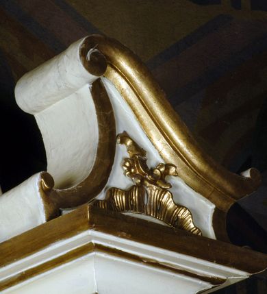 Zdjęcie nr 9: Ołtarz boczny umiejscowniony w prawym ramieniu transeptu, na jego krótszej ścianie. Architektoniczny, przyścienny, jednoosiowy, jednokondygnacyjny ze zwieńczeniem. Mensa drewniana w postaci stołu wspartego na czterech nogach naśladujących w formie filary z impostowymi, niezdobionymi kapitelami. Bez antepedium. Tabernakulum drewniane, skrzynkowe, jednodrzwiowe, w formie architektonicznej. Drzwiczki prostokątne, zamknięte półkoliście z płaskorzeźbionym, złoconym kielichem z hostią umieszczonym na srebrzonych obłokach. Jego lico artykułowane pilastrami o kanelurowanych trzonach i kompozytowych kapitelach, dźwigających wyłamany na ich osi, profilowany gzyms. Całość ujęta wolutami. Retabulum posadowione na wysokim, dwudzielnym, rozczłonkowanym architektonicznie cokole, dekorowanym prostokątnymi płycinami o złoconych brzegach. Przednie ramiona cokołu ustawione ukośnie w stosunku do osi ołtarza. Na nich złocone na całej wysokości kolumny o kompozytowych kapitelach, wysunięte przed pilastry z pseudokorynckimi kapitelami i kanelurowanymi trzonami. Podpory dźwigają wyłamane na ich osi, pełne belkowanie, przerwane na osi ołtarza. Na nim odcinki przyczółka w postaci wolut. Na architraw belkowania, ponad kapitelami kolumn, nałożone pojedyncze liście akantu. Pola odcinków przyczółka dekorowane złoconymi rocaille'ami. W polu ołtarza prostokątna nisza zamknięta łukiem półkolistym. Nisza ujęta złoconą, profilowaną ramą dekorowaną perełkowaniem. W niej pełnoplastyczna figura Chrystusa wskazującego na swoje serce. Wysokie, dużych rozmiarów zwieńczenie w kształcie łuku kotarowego o ściętym wierzchołku zamknięte łukiem wyniesionym, na osi którego kartusz wolutowy z zatkniętym u góry pojedynczym liściem akantu. Podcięte boki zwieńczenia zdobione przy brzegach złoceniem. W polu owalny obraz w złoconej, profilowanej ramie przedstawiający św. Kazimierza królewicza. Poniżej obrazu złocony, płaskorzeźbiony feston złożony z kampanul (brak jego prawej części). Na tylnych postumentach, również ustawionych ukośnie, na niewielkich cokołach, pełnoplastyczne figury klęczących na obłokach aniołów w szatach w kolorze zielonym i czerwonym, ukazanych w dynamicznych pozach. Anioł z lewej strony z dłońmi wskazującymi na piersi, prawy z dłońmi skrzyżowanymi na nich. Figury w pełni polichromowane w partiach karnacji oraz szat, gdzie dodatkowo złocone. Skrzydła utrzymane w tęczowych barwach, częściowo złocone. Wydłużone twarze z długimi wąskimi nosami oraz migdałowymi oczami. Włosy kręcone. Ołtarz pomalowany na kremowo. Złocenia w partiach ornamentu, załomach dekoracji architektonicznej, ramach obrazów oraz na kolumnach (całościowo).