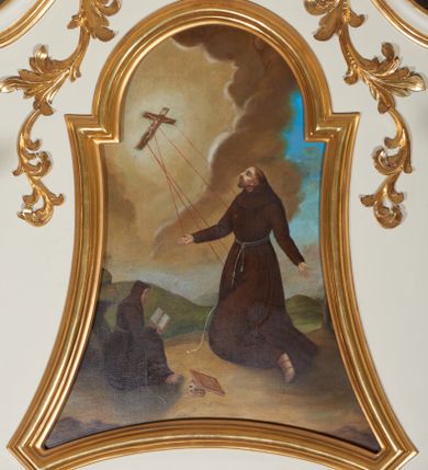 Zdjęcie nr 1: Obraz w kształcie stojącego prostokąta o wklęsłych bokach, od góry zamkniętego łukiem półkolistym, nadwieszonym. W centrum kompozycji przedstawienie klęczącego św. Franciszka otrzymującego stygmaty; głowa uniesiona lekko ku górze, ręce rozłożone szeroko na boki. Twarz widoczna z lewego profilu, okolona krótką i spiczasto zakończoną brodą, długi i prosty nos, małe oczy, na głowie tonsura. Święty ubrany jest w habit franciszkański, przewiązany sznurem. Przed nim, przy skałach siedzi czytający zakonnik w brązowym habicie, obok leżą zamknięta księga i czaszka. W oddali widoczny pejzaż górski. W lewym, górnym narożu postać ukrzyżowanego Chrystusa, z którego ran wychodzą czerwone promienie, tworzące stygmaty u św. Franciszka. W tle brunatno-żółte chmury na błękitnym niebie. Kolorystyka jasna, ciepła. Rama obrazu profilowana i złocona.