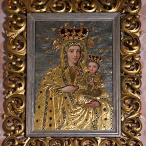 Zdjęcie nr 1: Obraz w formie stojącego prostokąta. Postacie Marii i Dzieciątka ozdobione pozłacanymi i posrebrzanymi, kameryzowanymi sukienkami odsłaniającymi malowane twarze, dłonie i stopy. Tło srebrne wypełnione repusowanym ornamentem roślinnym. Matka Boska w typie Hodegetrii. Maria ukazana w półpostaci, zwrócona lekko w lewą stronę. Na lewej ręce podtrzymuje Dzieciątko, prawą, uniesioną wskazuje na nie. Twarz owalna o delikatnych rysach, niewielkim nosie i dużych oczach. Ubrana jest w tunikę oraz okrywający również głowę płaszcz z szeroką lamówką dekorowaną rozetkami. Dzieciątko zwrócone w stronę Marii, lewą ręką przytrzymuje księgę, prawą unosi w geście błogosławieństwa. Ubrane w tunikę z długimi rękawami z lamówką dekorowaną kamieniami. Na głowach Dzieciątka i Marii zamknięte korony, wokół 12 gwiazd; korona Marii podtrzymywana przez dwa anioły. Z prawej strony na dole sukienki grawerowana inskrypcja „J(AN) GREGORCZYK / KRAKÓW / Imago haec 2 coronis / argenteis, veste autem et an/gelis e cupro in igne deauratis / adornata est piis parochianorum / oblatis cura Adalberti Lapiński [...]”. Dalszą część inskrypcji przesłania rama. Według przekazów brzmiała ona „Bolechowice A.D. 1897. Jan Gregorczyk”. Obok drugi napis również częściowo przesłonięty ramą obrazu „Wykonał [Jan Gregorczyk]”.