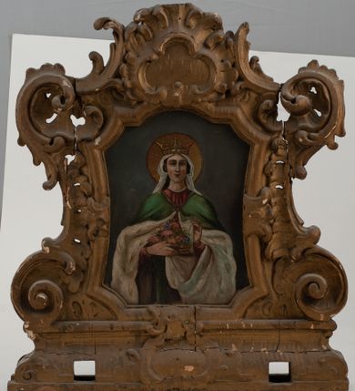 Zdjęcie nr 1: Feretron dwustronny z obrazami św. Elżbiety oraz św. Andrzeja ustawiony na prostopadłościennym cokole, zaopatrzonym w otwory na drążki do noszenia, pośrodku zdobionym rocaille&#039;owym kartuszem. Obrazy w kształcie stojących prostokątów o bokach wklęsło-wypukłych z uskokami u góry. Ujęte bogato dekorowaną, rzeźbioną ramą, zdobioną ornamentem rocaille&#039;owym, w narożach uformowanym na kształt czterech wolut. Struktura feretronu złocona. Święta Elżbieta ukazana w centrum kompozycji, stojąca w półpostaci z koszykiem kwiatów w prawej dłoni, lewą dłonią uchylająca połę płaszcza. Twarz owalna, z długim i wąskim nosem, mocno zarumienionymi policzkami; włosy długie, ciemnobrązowe, schowane pod welonem. Na głowie korona otwarta. Święta ubrana w czerwoną suknię z długimi rękawami oraz zielony płaszcz z białą podszewką spięty na piersi; na głowie biały welon, wokół niej złoty i kolisty nimb. Tło jednolite, szare. Po drugiej stronie obraz z wizerunkiem św. Andrzeja. Święty ukazany w postawie stojącej, do wysokości kolan, zwrócony w trzech czwartych w prawo, obejmujący prawą ręką krzyż. Twarz owalna, okolona bujną i siwą brodą; włosy długie spływające na plecy. Wokół głowy złoty i kolisty nimb. Ubrany w długą, zieloną suknię z długimi rękawami, obszytą przy szyi złotą lamówką, przewiązaną w talii oraz czerwony płaszcz zarzucony na lewe ramię. W tle sumarycznie oddany krajobraz. Niebo ciemnoniebieskie, nad horyzontem z różową poświatą.

