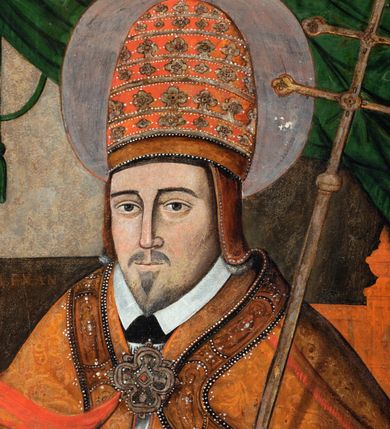 Zdjęcie nr 11: Obraz w kształcie stojącego prostokąta, w ozdobnej ramie. W centrum św. Grzegorz siedzący na tronie, ukazany do kolan, zwrócony en trois quarts w prawo; prawa ręka ugięta w łokciu z uniesioną otwartą dłonią, lewa wsparta na poręczy tronu z dłonią opuszczoną w dół podtrzymuje krzyż papieski. Twarz pociągła, o trójkątnej linii brody. Wyraźne rysy twarzy, oczy w kształcie migdałów, nos długi, prosty. Ubrany w obficie drapowaną w rurkowate fałdy rokietę o koronkowym zakończeniu rękawów. Na piersi czerwona stuła, na ramionach czerwona kapa o bogato zdobionej lamówce z przedstawieniem świętych, spięta na piersi dekoracyjną fibulą w formie kameryzowanej rozety. Na głowie tiara papieska. Wokół głowy nimb. W prawym górnym rogu obrazu podwieszona zielona kotara. W tle po lewej stronie stół z pasyjką oraz otwartą księgą. Na stole napis: S. ALEKSANDER. Kolorystyka ciemna, przytłumiona z przewagą brązów i czerwieni. Linearyzm, formy wydobyte konturem.