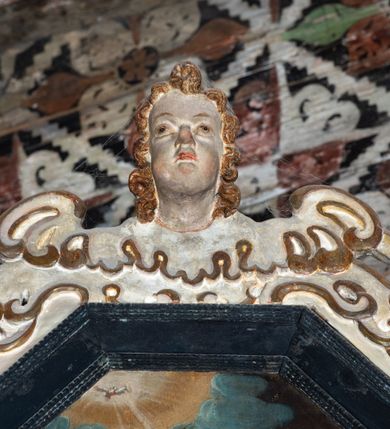 Zdjęcie nr 25: Nastawa ołtarzowa architektoniczna, jednoosiowa, jednokondygnacyjna, z wydzieloną predellą i zwieńczeniem, na cokole. Ołtarz kamienny z narzutem z tynku, sarkofagowy, wklęsło-wypukły. Mensa drewniana z portatylem z marmuru dębnickiego.Predella dekorowana płyciną w formie wydłużonego prostokąta z uszakami z malowanym przedstawieniem Bożego Narodzenia. Nastawa ujęta parą kolumn o kapitelach korynckich podtrzymujących pełne belkowanie belkowanie i gzyms, w części środkowej wyłamane ku górze trójbocznie. W polu środkowym nisza w formie stojącego prostokąta z uszakami, ujęta prostą ramą, wewnątrz gotycka szafa z figurą Matki Boskiej z Dzieciątkiem i czterech świętych dziewic. Na belkowaniu, w osi podpór figury św. Stanisława i św. Marcina (?). W zwieńczeniu ośmioboczny obraz z przedstawieniem Zwiastowania, w prostej ramie oraz bogatym obramieniu z ażurowych motywów ornamentu małżowinowo-chrząstkowego; u szczytu główka aniołka ze skrzydłami. Nastawa flankowana uszami utworzonymi z motywów ornamentu małżowinowo-chrząstkowego. W polu ponad niszą z obrazem rzeźbiona półpostać Boga Ojca. Gzyms u spodu dekorowany ornamentem małżowinowo-chrząstkowym. Struktura polichromowana na czarno, kapitele kolumn i część ornamentów srebrzone, pozostałe motywy ornamentalne złocone.