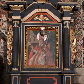 Zdjęcie nr 1: Nastawa ołtarzowa architektoniczna, jednoosiowa, jednokondygnacyjna z wydzieloną predellą i zwieńczeniem. Mensa drewniana. Kondygnacja ujęta parą kolumn o kompozytowych kapitelach podtrzymujących architraw i fryz oraz gzyms, nad polem środkowym formę wyłamane ku górze trójbocznie, występujące w osi podpór. W polu środkowym nisza w formie stojącego prostokąta ujętego prostą ramą; wewnątrz obraz Św. Grzegorz. W polu, ponad obrazem, główka aniołka ze skrzydłami.  W zwieńczeniu Oko Opatrzności w glorii promienistej, flankowane odcinkami przerwanego przyczółka oraz rzeźby Św. Piotr i Św. Andrzej umieszczone w osi podpór. Nastawa ujęta uszami utworzonymi z motywów stylizowanej małżowiny. Cokoły kolumn i predella dekorowane płycinami. Nisza w polu środkowym ujęta ornamentem roślinnym. u spodu fragmenty gzymsu dekorowane ornamentem roślinno-geometrycznym.Struktura polichromowana na czarno, profile srebrzone, motywy ornamentalne złocone. Na odwrocie portatylu napis: ANNO DNI 1761. DIE 7 …. IN ECCLESIA CATHEDRALI HOC ALTARE PORTATILE [CONSECR]ATUM EST AB ILUSTRISSIMO REVENDERISSIMO DOMINO TOMAE ZIENGO EPISCOPO&#039; AREOPOLITANO ET SUFRAGANO RIE ALBAE RUSSIAE CUSTODIE PRAELATIAE CATHEDRALI VILNENSI SECRETARIO MAGNE DUCATI LITHUANIAE CUI IMPOSITAE SUNT RELIQUIAE SANCTORUM EUTYCHII ANDFUANDI ET ALIIS MILIUM MARTYRUM ET QUORAM FIDEN … ET SIGILLO MUNIO.…. Pieczęć z herbem własnym Poniżej herb Zadzika i napis: ANTONIUS ZAUDZI CRAC CAPIT. VOTTO … HOC ALTARE PORTATILE ANNO 1761 CONSECRATUM ANNO 1847 SEPTEMBRIS 16 ILUSTRISSIMO REVENDERISSIMO DOMINO CASEMIRO DMOCHOWSKI EPISCOPO MITTER… SUFFR. CURANIENSE … EQUITE RECTIS ET INVENTIS INTROIS? SACER …FERIBUS RELIQUII SIGILLO EIUSDEM ILUSTRISSIMI EPISCOPI MUNITUM TESOR EGO JACOBUS CAROLEWICZ VICAR. ECCLEIAE CATHEDRALI VILNENSIS ORDINARIUS SANCTI STANISLAI TERIUM CLASSIQUES MPR&#039; [MANU PROPRIAE]