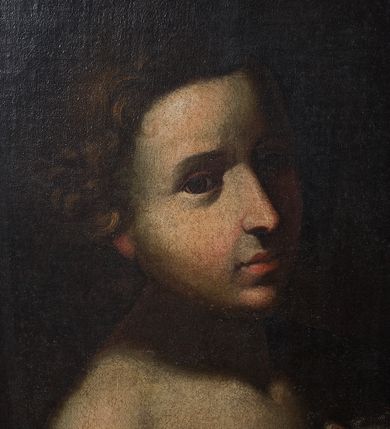 Zdjęcie nr 3: Obraz o kształcie stojącego prostokąta, w szerokiej, drewnianej ramie przedstawia św. Jana Chrzciciela z barankiem i banderolą z napisem &quot;ECCE AGNUS DEI&quot;. Święty ukazany w półpostaci, zwrócony w trzech czwartych w lewo. Jego twarz jest pociągła, włosy krótkie, kręcone. Obok niego widoczny baranek, z głową zwróconą frontalnie. W lewej ręce trzyma krzyż z banderolą. Tło gładkie, ciemne. 