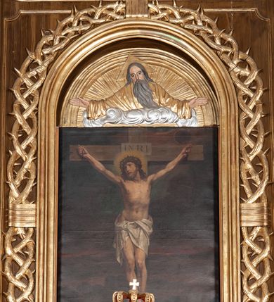 Zdjęcie nr 13: Ołtarz przyścienny, architektoniczny, jednoosiowy, jednokondygnacyjny ze zwieńczeniem. Mensa drewniana w kształcie prostopadłościennej skrzyni z narożami lekko wysuniętymi przed jej lico. Antependium drewniane z umieszczoną w centrum prostokątną płyciną z płaskorzeźbioną sceną Ostatniej Wieczerzy według Leonarda da Vinci. Po bokach po dwie mniejsze płyciny w kształcie prostokąta stojącego wypełnione płaskorzeźbioną, złoconą dekoracją z winnym gronem, kłosami, kwiatami oraz muszlą palmetową. 
Tabernakulum w kształcie prostopadłościennej, obitej metalową blachą skrzynki, dwudrzwiowe. Na drzwiczkach odlewana dekoracja z kłosów i winnych gron, powyżej gorejące serce. Tabernakulum ujęte drewnianym tronem wystawienia w formie ażurowej kolumnady na planie półkola. Zwieńczone ażurowymi wolutami tworzącymi formę baldachimu. U szczytu korona zamknięta, u jej podstawy Baranek Apokaliptyczny. 
Retabulum ustawione na wysokim cokole z bokami zwróconymi pod kątem 45 stopni, zwieńczonym wydatnym profilowanym gzymsem. Na ścianach cokołów uskrzydlone główki aniołów z podwieszonym ornamentem o motywach cęgowych i roślinnych. Kondygnacja flankowana jest parą kolumn podtrzymujących niepełne belkowanie. Kolumny o kapitelach kompozytowych, marmoryzowanych trzonach, z nałożoną do połowy dekoracją w formie ornamentalnej wici roślinnej złożonej z motywów akantu, rocaille&#039;u, palmety i ornamentu cęgowego. Na gzymsie fragmenty przerwanego trójkątnego przyczółka, na których siedzą pełnoplastyczne figury aniołków. Pole główne ołtarza o lekko zaoblonych narożach, w jego centrum złocona, profilowana rama w otoku z cierniowej korony, o kształcie prostokąta stojącego zakończonego półkoliście. Pośrodku obraz Matki Boskiej Częstochowskiej oraz obraz Ukrzyżowanie na zasuwie, ponad którym umieszczona jest płaskorzeźba Boga Ojca. Powyżej, na osi ołtarza złocona korona z krzyżykiem. 
Zwieńczenie ujęte jest kolumnami analogicznymi jak w kondygnacji dźwigającymi niepełne, przełamane na osi podpór belkowanie o linii wklęsło-wypukłej. W polu promienista gloria z gołębicą Ducha Świętego na tle obłoków. Po bokach zwieńczenia znajdują się spływy wolutowe dekorowane kwiatami. U szczytu krzyż wyrastający z palmety. Ołtarz malowany na kolor brązowy, złocenia w partiach profili elementów architektonicznych i ornamentów złocone, detale srebrzone.