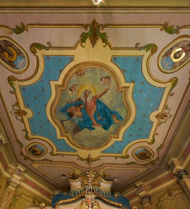 Zdjęcie nr 36: Polichromia ścian kościoła odpowiada podziałom architektonicznym wnętrza wydzielonym przez pilastry. Malowany zielony cokół w jednej czwartej wysokości ścian wyodrębniony jest pasem ornamentu geometrycznego, w nawie w jego polu znajdują się żółte prostokąty z dekoracją geometryczną, w prezbiterium malowana jasnozielona tkanina z dwoma pasami ornamentu roślinnego, medalionami z monogramami Marii i koronami oraz z motywem lilii heraldycznych i rozet. Trzony pilastrów wnętrza bladożółte z malowanymi płycinami dekorowanymi kampanulami, głowice zdobione malowanym kimationem. Na osi pilastrów, w partii fryzu, na tle niebieskich prostokątów uskrzydlone główki anielskie, pomiędzy nimi fryz wypełniony różowo-pomarańczowymi malowanymi płycinami w błękitnym obramieniu o fantazyjnym wykroju, dekorowanymi kampanulami. Belkowanie zamknięte malowanym pasem ornamentu geometrycznego. W polach pomiędzy pilastrami malowane płyciny o fantazyjnym kształcie zbliżonym do prostokąta, ujęte ramą zakończoną kartuszem, ich pola wypełnione są dekoracją geometryczną składającą się z krzyży równoramiennych w glorii i rozet wykonanych techniką patronową. Otwory okienne ujęte są malowanymi, imitującymi profilowanie obramieniami, otwory drzwiowe iluzjonistycznymi portalami z uszakami: portal w nawie zwieńczony jest kartuszem, a portal w prezbiterium zwieńczony jest szczytem zamkniętym fragmentem gzymsu w formie łuku segmentowego nadwieszonego podtrzymywanym przez spływy wolutowe. Pod chórem muzycznym malowane tablice pamiątkowe ujęte ramą, na ścianie północnej z napisem: „Ecclam hanc sub titulo Assumptionis B.V. Mariae a strenuo / milite Wierzbięta in Branice et Ruszcza Haerede pimo in / Wola juxta fines villae Stryjów a D. 1386 fundatam decimis / ex praedio Branice a colonis Stryjów, Wola, cuius sors est Grabie / Szczurów Zymbrzeg et ibidem taberna cum duobus pratis ac lacubus / Orzek et Piotrek ditatam, proper alluviem Vistulae  curatus suus / in hunc locum, qui erat pratum Gruczyn, ecclae dotale transtulit, / Hac tandem post annos 356 collapsa, quam vides, A.R.D. Jacobus Cichoński, parochus Grabiensis a.D. 1742 in loco desolatae  novam erexit. / Consecravit Illmus ac Rmus Michaël Kunicki, Sufraganeus Eppus. / Cracoviensis, Abbas Clarae Tumbae a D. 1749. / Restauravit A.R.D. Josephus Raźny, parochus Grabiensis a.D. 1907. / e colectis parochianorum.”; na ścianie południowej z napisem: „Ku Pamięci! / Dzieci Moje Najmilsze - Ja Prastara Świątynia / Polska dziękuję Wam za serdeczną troskę / o mnie. Oto dzięki Waszym ofiarom Drodzy / Rodzice i Twoim wysiłkom Kochana Młodzieży / w r. 1959 odnowiło się moje oblicze - rozjaśniały /  moje ołtarze, a w r. 1960 zabrzmiał mój nowy / organ na większą chwałę Bożą. Ja Was za to / rodzę na nowo do życia łaski. Ja Was błogosławię / na życie rodzinne. Ja Was prowadzę ku Bogu. Ja / Was także żegnam poraz ostatni, gdy przechodzicie / z tego padołu płaczu do wieczności, aby / Was znowu powitać kiedyś w niebie.”. Na ścianie zachodniej, pod chórem, nad środkowym otworem przejściowym pozostałości dawnego iluzjonistycznego portalu z kartuszem herbowym. Na stropie prezbiterium wydzielone pole o kształcie powtarzającym plan prezbiterium, wewnątrz pole w formie kwadratu o wklęsłych narożach z wpisanym polem o fantazyjnym zarysie zbliżonym do owalu ze sceną Wniebowzięcia Najświętszej Marii Panny. W narożach owalne pola z czterema istotami apokaliptycznymi. Prosta belka tęczowa w kolorze zielonym, o profilowaniach w kolorze niebieskim i różowym, z napisem: „JEZU ZMIŁUJ SIĘ NAD NAMI”. Na stropie nawy prostokątne pole wydzielone grubym bladoróżowym obramieniem z płycinami o nieregularnym kształcie wypełnionymi kratką regencyjną i rozetami alternowanymi medalionami z rozetami, naroża dekorowane są wstęgą regencyjną i akantem. Wewnątrz pole o fantazyjnym wykroju zbliżonym do owalu ze sceną Koronacji Najświętszej Marii Panny, flankowane przez dwie malowane błękitne płyciny o nieregularnym kształcie wypełnione rozetkami. W narożach, w ozdobnych kartuszach herby Pogoni Litewskiej i Orła Białego.
