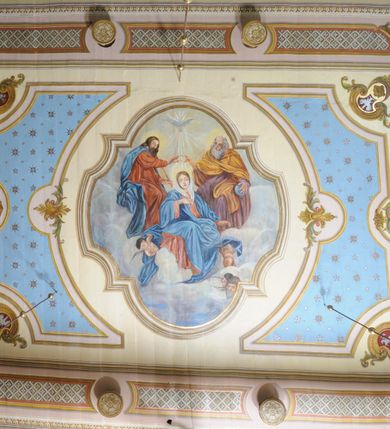 Zdjęcie nr 34: Polichromia ścian kościoła odpowiada podziałom architektonicznym wnętrza wydzielonym przez pilastry. Malowany zielony cokół w jednej czwartej wysokości ścian wyodrębniony jest pasem ornamentu geometrycznego, w nawie w jego polu znajdują się żółte prostokąty z dekoracją geometryczną, w prezbiterium malowana jasnozielona tkanina z dwoma pasami ornamentu roślinnego, medalionami z monogramami Marii i koronami oraz z motywem lilii heraldycznych i rozet. Trzony pilastrów wnętrza bladożółte z malowanymi płycinami dekorowanymi kampanulami, głowice zdobione malowanym kimationem. Na osi pilastrów, w partii fryzu, na tle niebieskich prostokątów uskrzydlone główki anielskie, pomiędzy nimi fryz wypełniony różowo-pomarańczowymi malowanymi płycinami w błękitnym obramieniu o fantazyjnym wykroju, dekorowanymi kampanulami. Belkowanie zamknięte malowanym pasem ornamentu geometrycznego. W polach pomiędzy pilastrami malowane płyciny o fantazyjnym kształcie zbliżonym do prostokąta, ujęte ramą zakończoną kartuszem, ich pola wypełnione są dekoracją geometryczną składającą się z krzyży równoramiennych w glorii i rozet wykonanych techniką patronową. Otwory okienne ujęte są malowanymi, imitującymi profilowanie obramieniami, otwory drzwiowe iluzjonistycznymi portalami z uszakami: portal w nawie zwieńczony jest kartuszem, a portal w prezbiterium zwieńczony jest szczytem zamkniętym fragmentem gzymsu w formie łuku segmentowego nadwieszonego podtrzymywanym przez spływy wolutowe. Pod chórem muzycznym malowane tablice pamiątkowe ujęte ramą, na ścianie północnej z napisem: „Ecclam hanc sub titulo Assumptionis B.V. Mariae a strenuo / milite Wierzbięta in Branice et Ruszcza Haerede pimo in / Wola juxta fines villae Stryjów a D. 1386 fundatam decimis / ex praedio Branice a colonis Stryjów, Wola, cuius sors est Grabie / Szczurów Zymbrzeg et ibidem taberna cum duobus pratis ac lacubus / Orzek et Piotrek ditatam, proper alluviem Vistulae  curatus suus / in hunc locum, qui erat pratum Gruczyn, ecclae dotale transtulit, / Hac tandem post annos 356 collapsa, quam vides, A.R.D. Jacobus Cichoński, parochus Grabiensis a.D. 1742 in loco desolatae  novam erexit. / Consecravit Illmus ac Rmus Michaël Kunicki, Sufraganeus Eppus. / Cracoviensis, Abbas Clarae Tumbae a D. 1749. / Restauravit A.R.D. Josephus Raźny, parochus Grabiensis a.D. 1907. / e colectis parochianorum.”; na ścianie południowej z napisem: „Ku Pamięci! / Dzieci Moje Najmilsze - Ja Prastara Świątynia / Polska dziękuję Wam za serdeczną troskę / o mnie. Oto dzięki Waszym ofiarom Drodzy / Rodzice i Twoim wysiłkom Kochana Młodzieży / w r. 1959 odnowiło się moje oblicze - rozjaśniały /  moje ołtarze, a w r. 1960 zabrzmiał mój nowy / organ na większą chwałę Bożą. Ja Was za to / rodzę na nowo do życia łaski. Ja Was błogosławię / na życie rodzinne. Ja Was prowadzę ku Bogu. Ja / Was także żegnam poraz ostatni, gdy przechodzicie / z tego padołu płaczu do wieczności, aby / Was znowu powitać kiedyś w niebie.”. Na ścianie zachodniej, pod chórem, nad środkowym otworem przejściowym pozostałości dawnego iluzjonistycznego portalu z kartuszem herbowym. Na stropie prezbiterium wydzielone pole o kształcie powtarzającym plan prezbiterium, wewnątrz pole w formie kwadratu o wklęsłych narożach z wpisanym polem o fantazyjnym zarysie zbliżonym do owalu ze sceną Wniebowzięcia Najświętszej Marii Panny. W narożach owalne pola z czterema istotami apokaliptycznymi. Prosta belka tęczowa w kolorze zielonym, o profilowaniach w kolorze niebieskim i różowym, z napisem: „JEZU ZMIŁUJ SIĘ NAD NAMI”. Na stropie nawy prostokątne pole wydzielone grubym bladoróżowym obramieniem z płycinami o nieregularnym kształcie wypełnionymi kratką regencyjną i rozetami alternowanymi medalionami z rozetami, naroża dekorowane są wstęgą regencyjną i akantem. Wewnątrz pole o fantazyjnym wykroju zbliżonym do owalu ze sceną Koronacji Najświętszej Marii Panny, flankowane przez dwie malowane błękitne płyciny o nieregularnym kształcie wypełnione rozetkami. W narożach, w ozdobnych kartuszach herby Pogoni Litewskiej i Orła Białego.
