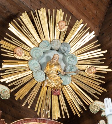 Zdjęcie nr 6: Ołtarz przyścienny, architektoniczny, jednokondygnacyjny, jednoosiowy ze zwieńczeniem. Mensa prostopadłościenna, drewniana, ustawiona na cokole, zamknięta profilowanym gzymsem. Antepedium zdobione malowaną płyciną w kształcie leżącego prostokąta o wklęsłych narożach i zryzalitowanym górnym i dolnym boku. W polu monogram IHS otoczony wieńcem z kłosów zbóż. Tło jasnoniebieskie, fakturowane w ciemnoszare plamki. Nastawa ołtarzowa ustawiona na niskim cokole o wysuniętych do przodu impostach, na których ustawiona jest para kolumn, wspierających przerwane belkowanie i wolutowy przyczółek. Pośrodku w ramie ozdobionej płaskorzeźbionymi liśćmi obraz Matki Boskiej Różańcowej w kształcie stojącego prostokąta, zamkniętego łukiem wklęsło-wypukłym z uskokami. Po bokach obrazu zwisy z kamapnul. Fryz dekorowany liśćmi akantu i rozetkami. Na tle kolumn prostokątne płyciny. W zwieńczeniu monogram maryjny na tle promienistej glorii z czterema uskrzydlonymi główkami anielskimi. Po bokach ołtarza akantowe uszy, przeplecione karbowaną wstęgą. Imposty w partii cokołu zdobione płycinami w kształcie niewielkich prostokątów, wypełnionych liśćmi akantu. Struktura malowana na kolor ciemnoniebieski i fakturowana w szare plamki, trzony kolumn marmoryzowane na kolor zielono-beżowy, profilowania na kolor bordowy, detale i ornamentyka złocone. 