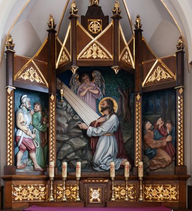 Zdjęcie nr 1: Nastawa ołtarzowa architektoniczna, trójosiowa, jednokondygnacyjna, ustawiona na niskim cokole, formowana na kształt tryptyku o skrzydłach bocznych ustawionych ukośnie. Ołtarz drewniany, prostopadłościenny, mensa drewniana. Antepedium w formie leżącego prostokąta zdobione trzema płycinami w kształcie stojących prostokątów dekorowanymi przecinającymi się listwami i stylizowaną wicią roślinną. Cokół wsparty na dwóch kolumienkach o geometrycznie dekorowanych bazach i kapitelach, zdobiony czterema płycinami w kształcie leżących prostokątów, wypełnionych motywami roślinno-geometrycznmi. Tabernakulum w formie prostopadłościennej skrzynki, po bokach flankowane pilastrami o zygzakowato rzeźbionym trzonie, zwieńczone profilowanym gzymsem. Na drzwiczkach płycina z monogramem IHS w polu, umieszczonym na tle czterech wiązek promieni. Osie nastawy oddzielone pilastrami, zwieńczonymi pinaklami i geometrycznymi kwiatonami. W polu głównym płaskorzeźba przedstawiająca Modlitwę w Ogrójcu. W skrzydle po lewej stronie dalsza część sceny z postaciami żołnierza i Judasza, a w skrzydle prawym trzej śpiący uczniowie. Nad polem głównym baldachim z dwoma nadwieszonymi pinaklami, dekorowany trójkątnymi płycinami zdobionymi płaskorzeźbioną wicią roślinną. Szczyt w kształcie stojącego prostokąta z kwadratową płyciną w polu, zamknięty trzema trójkątami i krzyżykiem łacińskim. Struktura w kolorze naturalnego drewna; ornamentyka i detale złocone. 