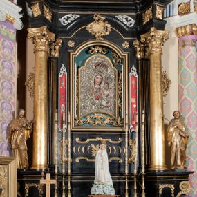 Zdjęcie nr 1: Ołtarz architektoniczny, jednoosiowy, jednokondygnacyjny ze zwieńczeniem. Ołtarz drewniany prostopadłościenny, mensa drewniana z portatylem z marmuru dębnickiego. Antepedium dekorowane płyciną w formie leżącego prostokąta o wklęsłych narożach z monogramem maryjnym w polu. Na ściankach bocznych ołtarza płyciny w formie kwadratu o wklęsłych narożach. Retabulum jest ujęte parą ustawionych pod kątem na cokołach kolumn o kompozytowych kapitelach stojących na tle zwielokrotnionych pilastrów o kanelowanych trzonach, dźwigających pełne belkowanie z wydatnym gzymsem, wyłamane na osi podpór oraz przerwany, półkolisty przyczółek z figurami siedzących puttów; architraw nad polem środkowym przybiera kształt łuku odcinkowego. Po zewnętrznej stronie kolumn figury św. Jana Nepomucena i św. Jana Kantego na wydatnych konsolach. W polu środkowym nisza ujęta profilowaną ramą w formie stojącego prostokąta zamkniętego łukiem odcinkowym nadwieszonym z obrazem Matki Boskiej z Dzieciątkiem. Zwieńczenie w formie stojącego prostokąta ujęte zwielokrotnionymi pilastrami podtrzymującymi profilowany gzyms w kształcie łuku oślego. W polu owalny obraz "Św. Andrzej". Cokoły dekorowane płycinami utworzonymi z ornamentu roślinnego, konsole zdobione muszlą o kształcie falbany. Nad polem środkowym rocaille'owy kartusz, flankowany akantem. U spodu obrazu dekoracja roślinno-geometryczna z rozetą ujętą rocaiile'm. Obraz flankowany gablotami z wotami w ramie utworzonej z akantu i sznura. Fryz impostów zdobiony rozetami; nad polem środkowym akantem. Kondygnacja ujęta ażurowymi uszami utworzonymi z rocaille'ów i kwiatów róż. Trzony pilastrów zwieńczenia dekorowane rocaille'em i roślinnymi festonami. Pole obrazowe otoczone fragmentami rocaille'u, zwieńczone muszlą. Nad zwieńczeniem mitra książęca. Struktura polichromowana w kolorze czarnym; kolumny, ornamentyka i profile złocone.