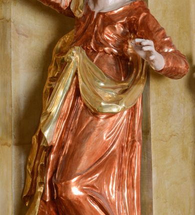 Zdjęcie nr 9: Nastawa ołtarzowa architektoniczna, jednoosiowa, jednokondygnacyjna ze zwieńczeniem. Ołtarz drewniany, prostopadłościenny, mensa drewniana z kamiennym portatylem. Antepedium w kształcie leżącego prostokąta, ujętego profilowaną ramą z aplikowanym monogramem Maryii w polu. Na ołtarzu ustawiony obraz Matki Boskiej Nieustającej Pomocy. Retabulum ustawione na dwustrefowym cokole, ujęte parą kolumn o kapitelach kompozytowych, przewiązanych poniżej połowy rocaille'ową opaską, stojących na tle zwielokrotnionych pilastrów. Podpory dźwigają pełne belkowanie, wyłamane na ich osi, ustawione ukośnie, nad polem środkowym przyjmujące kształt łuku odcinkowego. W polu środkowym głęboka nisza w formie stojącego prostokąta zamkniętego łukiem wklęsło-wypukłym z uskokami, ujęta profilowaną ramą, z figurą Matki Boskiej z Lourdes. Niszę flankują dwie figury: św. Jana i św. Mateusza ustawione na konsolach. Na belkowaniu, na linii podpór cokoły z figurami św. Emeryka i św. Władysława. Zwieńczenie przyjmuje kształt stojącego prostokąta flankowanego spływami wolutowymi, zamkniętego gzymsem przechodzącym w dwie woluty. Całość zakończona promienistą glorią z monogramem Marii otoczonym obłokami, flankowana figurkami aniołków. W polu zwieńczenia rama w formie stojącego prostokąta o wklęsłych bokach i dolnych narożach, zamknięta wolutami, z figurą św. Stefana w polu, ustawioną na wsporniku. Nastawa ujęta po bokach ażurowymi uszami utworzonymi z rocaille'u i prostej karbowanej wstęgi. Całość obficie dekorowana ornamentem rocaille'owym oraz zwisami kwiatowymi. Struktura marmoryzowana w kolorze żółtym, profile marmoryzowane na seledynowo, ornamentyka i profilowania złocone.

