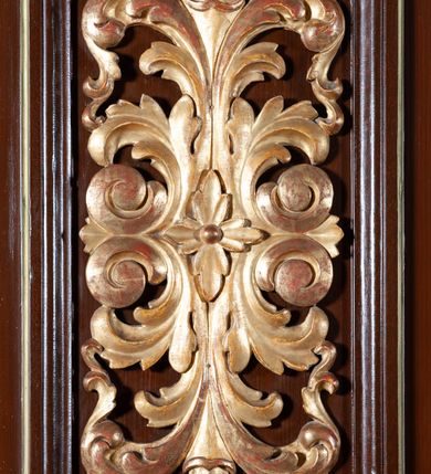 Zdjęcie nr 4: Ambona zawieszona w arkadzie tęczy, dostępna jednobiegowymi schodami od wschodu, od strony wejścia do zakrystii. Kosz na rzucie ośmioboku, opięty smukłymi kolumienkami o gładkich trzonach i kompozytowych kapitelach, ustawionymi występujących wybrzuszonych postumentach i wspierającymi gzyms występujący na nimi. Boki kosza na przemian gładkie i ozdobione nałożonymi rzeźbionymi motywami roślinnymi. Kosz nadwieszony na konsoli w kształcie spłaszczonego ostrosłupa. Zaplecek prostokątny, z prostokątną zamkniętą półkoliście płyciną, w której w górnej części litery IHS z krzyżem, otoczony promieniami. Baldachim powtarza rzut i podziały kosza, ozdobiomy lambrekinem, nakryty spłaszczonym ostrosłupem zwieńczonym prostym krzyżykiem. Na podniebiu rzeźbiona Gołębica Ducha Świętego wśród promieni. Struktura pomalowana na brązowo, podniebie baldachimu w kolorze bękitnym, ornamenty i detale architektoniczne złocone. 