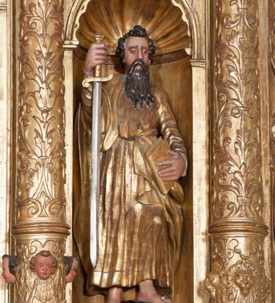 Zdjęcie nr 9: Ołtarz architektoniczny, z wydzieloną predellą, trójosiowy, dwukondygnacyjny ze zwieńczeniem. Predella węższa od nastawy, rozszerzająca się ku górze. Dolna kondygnacja artykułowana kolumnami o trzonach przedzielonych opaską w jednej trzeciej wysokości, zdobionych główkami aniołków, girlandami i dekoracją kandelabrową; kapitele kompozytowe; w osiach zewnętrznych kolumny nadwieszone na konsolach, w osiach wewnętrznych ustawione na postumentach. Kolumny wspierają belkowanie i gzyms występujące nad nimi. W polu środkowym prostokątna nisza zamknięta półkoliście, w niej obraz: Chrzest Chrystusa; w polach bocznych mniejsze nisze prostokątne zamknięte półkoliście, muszlowe, w nich rzeźby: Św. Piotr i Św. Paweł. Górna kondygnacja ujęta kolumnami o kręconych trzonach z dekoracją roślinną i kompozytowych kapitelach, wspierającymi belkowanie i profilowany gzyms. W polu środkowym nisza zamknięta półkoliście w niej obraz: Matka Boska z Dzieciątkiem. Po bokach obrazu rzeźby: Św. Anna (?) i Św. Marcin (?). Dolna i górna kondygnacje flankowane rzeźbionymi, ażurowymi uszakami z motywem herm aniołów. W osiach kolumn dolnej kondygnacji rzeźby: Św. Wojciech i Św. Stanisław. Zwieńczenie w kształcie półkolistego przyczółka wspartego na konsoli wchodzącej w pole górnej kondygnacji. W polu zwieńczenia płaskorzeźbione, półplastyczne przedstawienie Boga Ojca w popiersiu, flankowane wolutami z półpostaciami dwóch uskrzydlonych aniołów. Po bokach w zwieńczeniu, w osiach kolumn górnej kondygnacji, rzeźby uskrzydlonych aniołów.   W szczycie ołtarza na konsoli rzeźba: Św. Michał Archanioł. W przyłuczach nisz na obrazy, ponad niszami na rzeźby, w predelli, na konsolach i postumentach kolumn dolnej kondygnacji oraz na konsoli poniżej zwieńczenia uskrzydlone główki aniołków. Ponadto poniżej nisz, w tle kolumn oraz na belkowaniu płyciny ornamentalne z motywów roślinnych i motywy rautów. Struktura ołtarza, rzeźby i ornamenty złocone, karnacje i włosy polichromowane.  
