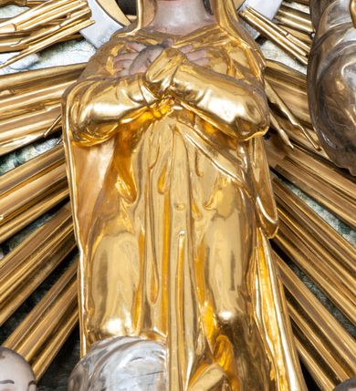 Zdjęcie nr 10: Nastawa ołtarzowa architektoniczna, trójosiowa z bramkami, jednokondygnacyjna ze zwieńczeniem. Ołtarz wysunięty do przodu, drewniany, sarkofagowy, wklęsło-wypukły, zwężający się ku dołowi, na profilowanym cokole, ujęty spływami wolutowymi; dekorowany w narożach palmetami, na froncie rocaille&#039;owy kartusz z malowanymi skrzyżowanymi kluczami w polu. Mensa drewniana z silnie wysuniętą, profilowaną krawędzią, z portatylem z piaskowca. 

Tabernakulum w formie prostopadłościennej skrzynki o wypukłej ściance frontowej, ujęte z przodu ukośnie dostawionymi pilastrami na cokołach z trzonami w formie wolut, dźwigającymi niepełne belkowanie, opasujące je z trzech stron, nad ścianką frontową przyjmujące falistą formę zwieńczoną rocaille&#039;m. Drzwiczki przyjmują kształt stojącego prostokąta zamkniętego łukiem półkolistym nadwieszonym, ujęte profilowaną ramą; w polu płaskorzeźbione przedstawienie kielicha z hostią w glorii na fakturowanym tle. Na belkowaniu, na osi podpór ustawiona jest para rocaille&#039;owych lichtarzy. Tron wystawienia architektoniczny, trójosiowy; oś środkowa ponad tabernakulum w postaci ażurowej niszy z cokołem na pasyjkę, tylna ścianka utworzona z rocaille&#039;u z kłosami zbóż; flankowana pilastrami zwieńczonymi falistym gzymsem, dźwigającymi ażurową, zamkniętą koronę. Podpory przechodzą w spływy wolutowe, ujmujące tabernakulum, na których końcach siedzi para adorujących puttów. Osie boczne są ujęte po bokach pilastrami dźwigającymi imposty podtrzymywane przez rocaille w partii trzonów oraz płonące wazony; pola wypełnione ażurowym rocaille&#039;m i palmetami przechodzącymi w podwójne lichtarze.

Retabulum na planie półowalu, osie boczne ustawione prostopadle do środkowej. Oś środkowa posadowiona na wysokim, dwustrefowym cokole. W pierwszej strefie cokołu prostokątna płycina z napisem: „Z INICJATYWY / KS. PROBOSZCZA ROMANA GORCZYŃSKIEGO / W LATACH 2001 - 2006 / WYKONANO REMONT KOŚCIOŁA I KONSERWACJĘ / WYPOSAŻENIA”. W drugiej strefie cokołu, pośrodku płycina w formie leżącego prostokąta o fantazyjnie wyciętych bokach z malowanym kartuszem herbowym, dzielonym na cztery pola. W lewym górnym polu kartusza umieszczony jest orzeł, poniżej dwójka dzieci w łódce, a po prawej stronie tarczy, w prawym górnym polu dwójka dzieci w łódce, poniżej orzeł. U spodu napis z chronostychem: „EREXIT, AC EXORNAVIT HONORIBVS SANCTI PETRI, / AC PAVLI APOSTOLI ILLVSTRISSIMVS LIBER BAR I WNBS(?) IOANELLY / A TOLVANA PROPPII X I”. Klejnotem jest hełm z pióropuszem zakończony półpostacią rycerza w zbroi, zaś labry mają formę bujnej wici akantowej.  Ryzality cokołów ozdobione są z trzech stron rocaille&#039;owymi płycinami; skrajne konsole rocaille&#039;m i różanymi gałązkami. Oś główna flankowana parą kolumn ustawioną na tle zwielokrotnionych pilastrów. Podpory dźwigają pełne belkowanie, przerwane nad polem środkowym, wyłamane na ich osi oraz przerwany wolutowy przyczółek. W polu środkowym podwójna, profilowana rama w formie stojącego prostokąta zamkniętego łukiem nadwieszonym z uskokami z obrazem św. Piotra i św. Pawła; flankowana przez figury św. Szymona po lewej stronie i św. Judy Tadeusza po prawej, ustawionymi na rocaille&#039;owych wspornikach. Ramy obrazu, trzony wewnętrznych pilastrów i pola za środkową parą figur dekorowane rocaille&#039;m. 

Zwieńczenie w formie zbliżonej do stojącego prostokąta, ujęte spływami wolutowymi, zamknięte falistym gzymsem przechodzącym w antytetycznie zwrócone woluty. Całość zwieńczona gołębicą Ducha Świętego w glorii promienistej. W polu rzeźbiarska grupa Koronacji Marii w glorii promienistej, pośród obłoków i uskrzydlonych główek anielskich. Dwa flankujące grupę putta  na obłokach trzymają banderole z napisem: „FILIA DEI PATRIS” i „MATER DEI FILII”, a kolejne dwa usadzone na szczycie: „VENI CORONABERIS” oraz „VENI SPONSA MEA”. Poniżej zwieńczenia w ażurowym kartuszu znajduje się napis: „QVA E/ST ISTA / QVAE PROGREDI/TUR QVASI AURORA / CONSURGENS / Cant 6.”. Na przyczółku siedzące figury św. Joachima po lewej stronie i św. Józefa po prawej, na gzymsie flankującym pole środkowe dwa putta trzymające słońce i księżyc, na zewnętrznych osiach dwa adorujące anioły. Spływy zwieńczenia dekorowane strzępiastymi liśćmi palmowymi, muszlą i rocaille’m. 

Osie boczne ustawione są na wysokim cokole, od zewnątrz ujęte pilastrami przechodzącymi w woluty, od wewnątrz sąsiadują z osią środkową. Pośrodku bramki z drzwiczkami zakończonymi gzymsem przyjmującym formę cokołu dla figur. Drzwiczki w formie stojącego prostokątna zamkniętego łukiem segmentowym nadwieszonym; osie na skraju ujęte konsolami stanowiącymi cokoły dla podpór. Ryzalit bramek zdobiony płyciną ze strzępiastym grzebieniem; drzwiczki z płyciną z rocaille&#039;m i kwiatowym zwisem na wstążce; powyższy cokół ujęty liśćmi palmowymi i rocaille&#039;m. Kondygnacja flankowana na skraju kolumną ustawioną na tle pilastru, które podtrzymują wyłamany gzyms zakończony wolutami ujmującymi szczyt o falistym przebiegu, na którym ustawiony jest duży płomienisty wazon. W polach ustawione są figury: po lewej się Jakuba Starszego, a po prawej św. Filipa. Na zwieńczeniach usadzone dwie figury aniołów. 

Struktura w całości marmoryzowana w kolorze zielono-brązowym; ornamentyka, kolumny złocone, detale srebrzone. Wszystkie kolumny w jednej trzeciej wysokości przedzielone rocaille’m, a fryz z elementami dekoracji rokokowej. Tabernakulum i tron wystawienia w całości złocone.

