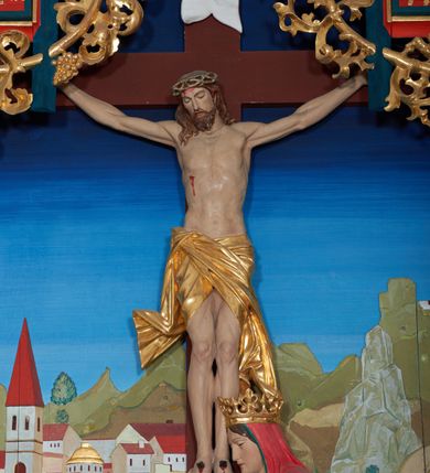 Zdjęcie nr 11: Ołtarz szafiasty, przyścienny, trójosiowy, jednokondygnacyjny ze zwieńczeniem. Mensa drewniana, prostopadłościenna. Antepedium z umieszczoną centralnie pseudopłyciną mieszczącą monogram IHS w akantowym otoku; boki zdobione, z lewej przedstawiony herb Łabędź. W części centralnej prostopadłościenne tabernakulum w formie kapliczki z ukośnie ustawionymi pilastrami zwieńczonymi pinaklami i kwiatonami. Predella u podstawy dekorowana fryzem palmetowym, wyżej pseudomaswerkowym, ostrołukowym ornamentem. Nastawa w formie tryptyku z neogotyckim, ażurowym zwieńczeniem zakończonym pinaklami i kwiatonem. Oś środkowa i osie boczne ujęte smukłymi, złoconymi kolumienkami o skręconych trzonach wspierającymi ażurową dekorację roślinną, w części centralnej uformowaną w kształt łuku w ośli grzbiet. W polu środkowym rzeźbiona scena Ukrzyżowania z figurą Chrystusa Ukrzyżowanego z klęczącą Marią Magdaleną obejmującą krzyż, umieszczona na tle górzystego pejzażu z widokiem Jerozolimy z lewej strony. W kwaterach bocznych, na tle pejzażu, płaskorzeźbione figury, po lewej stronie Maria na niewysokim postumencie z inskrypcją „S(ancta) Maria”, zwrócona w stronę krzyża; po prawej na postumencie z napisem „S(anctus) Johannes”, św. Jan Ewangelista trzymający kielich w lewej ręce. Wszystkie kwatery obwiedzione ramą ze złotą inskrypcją na czerwonym tle „Julianus de Skrzynno Dunin Brzeziński uxorque eius Eva cum matre sua Anastasia Morawska in honorem Dei Omnipotentis pro sua suorumque salute omniumque huius parochiae fidelium et prosperitiate et redemptione hoc jusferunt altare fieri A(nno) D(omini) 1892 salvo Leone XIII P(ontifice) M(aximo)”. Zwieńczenie ażurowe, płaskorzeźbione, w części centralnej powtarza kształt oślego grzbietu ze złoconym ornamentem stylizowanej wici roślinnej, w górnej części zamknięte pinaklami i kwiatonami. Kwatery boczne zwieńczone uszakami wypełnionymi ażurowym, złoconym suchym akantem, obwiedzione ornamentem ze stylizowanej wici roślinnej. Struktura malowana w odcieniu morskiej zieleni z czerwonymi detalami, ornamentyka złocona. Figury oraz tło kwater w pełni polichromowane.
