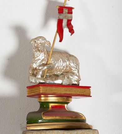 Zdjęcie nr 3: Komplet sześciu kamiennych konsol w formie męskich, brodatych głów, na które spływają żebra krzyżowego sklepienia w nawie głównej. Postać pierwsza o twarzy szerokiej, okolonej długim zarostem oraz włosami układającymi się w loki na czole. Oczy zamknięte, wydatny, prosty nos. Widoczne rurkowate bruzdy na czole. Postać druga o twarzy pociągłej, okolonej długim zarostem artykułowanym za pomocą rurkowatych fałd. Broda na końcu nieznacznie rozdwojona. Włosy proste ponad czołem tworzą trójkątne zakola. Oczy zamknięte, czoło pokryte bruzdami. Postać trzecia o trójkątnej twarzy z niskim, pokrytym bruzdami czołem i kręconych włosach. Oczy zamknięte. Postać czwarta o owalnej, pełnej twarzy, wystających kościach policzkowych. Zarost artykułowany za pomocą równoległych fałdek. Włosy układające się w loki ponad czołem. Oczy zamknięte. Postać piąta o szerokiej, płaskiej twarzy z gęstym zarostem. Długie, falowane wąsy, zamknięte oczy. Włosy ponad czołem układające się w loki. Postać szósta o pociągłej, podłużnej twarzy z zarostem. Długi, prosty nos, zamknięte oczy, niskie czoło ponad, którym bujne, proste włosy. Na przecięciach żeber dwa polichromowane zworniki z godłem herbu Drużyna oraz syglami „S(ebastian) L(ubomirski)" umieszczonymi na czerwonym tle, pierwszy ośmioboczny, drugi w kształcie wieloliścia. W podniebiu arkady tęczowej wolutowa konsola ustawiona na kapitelu pilastra w podniebiu łuku tęczowego. U podstawy konsoli, na osi umieszczony rollwerkowy kartusz mieszczący godło herbu Drużyna oraz sygle „S(ebastian) L(ubomirski)”. 