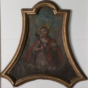 Zdjęcie nr 1: Obraz w kształcie trapezu o wklęsłych ramionach i dolnych narożach, zamknięty łukiem nadwieszonym, ujęty profilowaną, złoconą ramą. Święta ukazana w półpostaci, w trzech czwartych zwrócona prawo, w lewej dłoni trzyma czaszkę, a w prawej krucyfiks. Twarz okrągła z dużymi oczami i silnie zarumienionymi policzkami. Włosy ciemnobrązowe, spływające na plecy. Na głowie ma założony wianek biało-czerwonych róż, a wokół niej złocony, kolisty nimb. Ubrana jest w białą suknię, przewiązaną w talii niebieskim paskiem oraz czerwony płaszcz spływający na lewy bok. Dokoła świętej szare obłoki, w górnej części obrazu tło błękitne. 