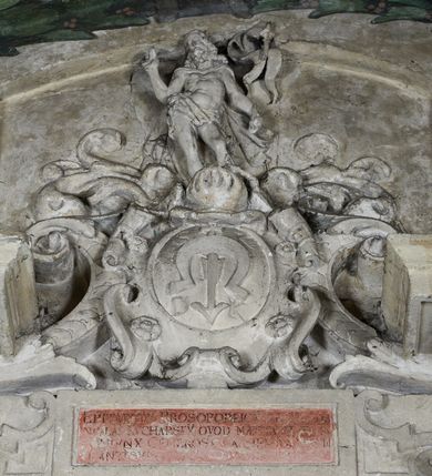 Zdjęcie nr 5: Epitafium w oprawie architektonicznej w formie aedikuli z płaskorzeźbioną półpostacią zmarłego oraz tablicą z inskrypcją; ujęte zdwojonymi pilastrami o kapitelach korynckich; trzony do połowy wysokości dekorowane płycinami, powyżej festonami i chwostami. Podpory dźwigają imposty zakończone cokołami z kulami. Zewnętrzne pilastry z wolutą w połowie wysokości. U spodu dwie woluty dekorowane perełkowaniem i kwiatami z szyszką w formie cokołu z kulą. Ponad niszą płyta ujęta wolutami. Całość zwieńczona kartuszem z herbem Odrowąż (?) flankowanym wolutami z labrami w postaci bujnej dekoracji roślinnej oraz płaskorzeźbiona figurą Chrystusa Zmartwychwstałego. O MORS CIELDELLIS? NVLLUM EST LIBIDIMINE DIGNA / NAM NVLLI PARCIT NVLLAQ(VE) DONA IVVANT.