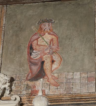 Zdjęcie nr 21: Prezbiterium. Strop pokryty dekoracją malarską imitującą kasetony wypełnione rozetami oraz umieszczonymi pomiędzy nimi krzyżami wypełnionymi liśćmi na ramionach i rozetami na skrzyżowaniu. Na ścianach bocznych prezbiterium, w arkadach podtrzymywanych przez kolumny popiersia apostołów oraz popiersia mężczyzn w strojach szlacheckich ukazane na tle zielonych obić (genealogia Chrystusa). Pod nimi fryz z łacińskimi napisami od dołu zdobiony girlandami z uskrzydlonymi główkami anielskimi oraz puklowanymi wazami. Na ścianach również herby: m.in. Łabędź, Jastrzębiec.  Nawa główna. Strop pokryty dekoracją malarską imitującą kasetony z rozetami. Na ścianach bocznych nawy głównej: na ścianie północnej cykl pasyjny w kwadratowych obramieniach z przedstawieniami: Modlitwa w Ogrojcu, Biczowanie Chrystusa, Chrystus Umęczony, Ecce Homo, Upadek pod krzyżem oraz słabo czytelny cykl maryjny z przedstawieniami: Zwiastowanie, Boże Narodzenie, Hołd Trzech Króli oraz Ucieczka do Egiptu i Rzeź niewiniątek, Jezus nauczający w świątyni. Na ścianie południowej nawy w arkadach umieszczono przedstawienia św. Wojciecha z wiosłem i św. Stanisława z Piotrowinem. Na balustradzie chóru muzycznego zachowały się częściowo trzy sceny ilustrujące przypowieść o bogaczu i Łazarzu oraz data: 1562. Kolorystyka pastelowa z przewagą zieleni, beżu i czerwieni z mocno zaznaczonymi konturami.