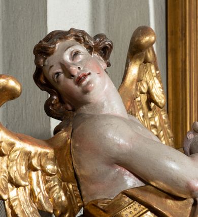 Zdjęcie nr 31: Ołtarz architektoniczny, jednoosiowy, jednokondygnacyjny ze zwieńczeniem, na cokole. Mensa drewniana umieszczona na drewnianej tumbie o wklęsło-wypukłych bokach. Antependium dekorowane rocaille’owym kartuszem z rytym gorejącym sercem, brzegi zdobione rocaille’em. W predelli przeszklona trumienka z figurą św. Jana Nepomucena, w profilowanej, złoconej ramie, na rocaillowej podstawie. Nastawa ujęta parami występujących do przodu filarów: wewnętrzne filary opięte pilastrami; zewnętrzne filary z wolutami zamiast trzonów, z figurami aniołów. Podpory dźwigają pełne belkowanie, przerwane nad polem środkowym. W polu nisza w kształcie stojącego prostokąta zamkniętego trójbocznie, w której obraz Święta Rodzina w profilowanej ramie. Przy filarach od wewnątrz rocaille’owe konsole z figurami św. Doroty i św. Katarzyny Aleksandryjskiej. Zwieńczenie w formie aedikuli zbliżonej do kwadratu o fantazyjnym wklęsło-wypukłym zamknięciu; ujęte pilastrami przechodzącymi w spływy wolutowe, opadające na belkowanie, tworzące postumenty dla figur św. Stefana i św. Emeryka. W polu zwieńczenia obraz z przedstawieniem Świętej Rodziny przy pracy, w kształcie kwadratu o wklęsłych narożach, w profilowanej ramie. Zwieńczenie zamknięte glorią promienistą z literami IHS w otoczeniu obłoków; na osi pilastrów rokokowe wazony z różami.W partii cokołów kanony w rocaille’owych ramach. Trzony pilastrów i woluty dekorowane rocaille’owymi płycinami, we fryzie rocaille. Nisza w polu środkowym ujęta rocaille’ami, zwieńczona mitrą książęcą, flankowana przez parę uskrzydlonych główek anielskich. Woluty zwieńczenia dekorowane motywami rocaille’ów. Rama obrazu w polu ujęta małżowiną, ornamentem roślinnym i rocaille’ami. Struktura marmoryzowana w odcieniu jasnoniebieskim, podpory, tumba i cokoły w odcieniu kości słoniowej; ornamentyka i profile złocone.