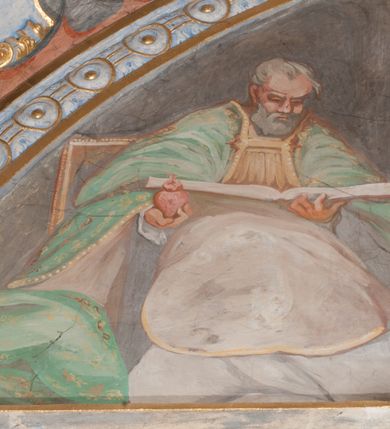 Zdjęcie nr 79: Iluzjonistyczną dekoracją malarską pokryto ściany kaplicy oraz strefę ponadcokołową: ściany tarczowe, pendentywy wokół stiukowych kartuszy herbowych oraz czaszę kopuły i wnętrze latarni. Ściany dolnej części podzielono na dwie strefy. Dolną tworzą zlokalizowane w narożach ścian iluzjonistycznie malowane pary nisz o konchach wypełnionych muszlą. W niszach ukazano osiem stojących frontalnie postaci starców, bez atrybutów i nimbów. Zapewne w ten sposób przedstawiono proroków lub apostołów. Każda z postaci ubrana jest w tunikę oraz płaszcz. Różnicuje je jedynie układ rąk, sposób kształtowania zarostu oraz kolorystyka szat. W drugiej strefie w przyłuczach arkad ukazano całopostaciowe przedstawienia uskrzydlonych aniołów trzymających narzędzia męki Pańskiej. Na ścianie wschodniej anioł prezentuje chustę Weroniki (z prawej) oraz latarnię (z lewej). Po bokach wejścia do kaplicy na ścianie północnej po prawej stronie anioł trzyma lancę i koronę cierniową, a po lewej krzyż. Z kolei na ścianie wschodniej po prawej ukazano anioła z drabiną, a po lewej z gąbką na trzcinie. Natomiast na ścianie południowej, po obu stronach zwieńczenia nagrobka, przedstawiono z prawej anioła z włócznią, a po lewej anioła z wiązką do biczowania. W tej strefie bezpośrednio przy łukach arkad wyobrażono leżące postacie geniuszy malowanych w technice en grisaille. Pod arkadą na ścianie wschodniej (ołtarzowej), ukazano dolną część owalnego jasno ugrowego baldachimu z lambrekinem i zielone, opadające paludamentum, rozsuwane kotarowo przez dwa uskrzydlone anioły. Dekoracja stanowi oprawę dla wiszącego tu obrazu Matki Boskiej z Dzieciątkiem w bogato rzeźbionej ramie. Z kolei na ścianie zachodniej wyobrażono monumentalną scenę Zdjęcia z krzyża. Jest to zwarta kompozycja ogniskująca się na wysokim drewnianym krzyżu, z którego ściągane jest martwe ciało Chrystusa. Z dwóch stron dłuższych ramion krzyż podtrzymują dwaj aniołowie. Ciało Jezusa opuszczane jest na białym pasie tkaniny przewiązanym pod jego ramionami. Chrystus ze zwisającą głową ma ręce ułożone wzdłuż ciała. Biodra przepasane ma białym perizonium. Jego skrzyżowane nogi są ugięte i jeszcze przybite gwoździem do krzyża. Gwóźdź wyciąga z nich obcęgami mężczyzna w niebieskiej, podwiniętej koszuli. Ciało opuszczają dwaj mężczyźni widoczni za poprzecznymi ramionami krzyża, trzymający końce taśmy. Człowiek z lewej strony w niebieskiej koszuli dodatkowo odbiera drugą białą taśmę od mężczyzny ubranego w szaroczarny strój. Osoba ta stoi na drabinie opartej o poprzeczne ramię krzyża. Drugi mężczyzna za krzyżem, w brązowej koszuli, lewą ręką trzyma koniec taśmy, a w uniesionej prawej młotek. Ciało Zbawiciela podtrzymuje lewą ręką kolejny mężczyzna stojący tyłem do widza na drugiej drabinie opartej o lewe ramię krzyża. Jest on ubrany w krótkie brązowe spodenki i bladozieloną koszulę. Pod krzyżem stoi zwarta siedmioosobowa grupa. Najprawdopodobniej z prawej strony ukazano św. Jana i Matkę Boską, na środku dwóch żołnierzy w ostro zakończonych hełmach, dwie kobiety, w tym zapewne Marię Magdalenę i starca widocznego z lewej strony kompozycji. Na ścianach tarczowych nad gzymsem wyobrażono po bokach okrągłych okien siedzących czterech ewangelistów i czterech ojców Kościoła. Na ścianie wschodniej znalazł się z prawej św. Jan z orłem, który w dziobie trzyma złoty kałamarz, a po lewej św. Mateusz rozmawiający z aniołem. Z kolei na ścianie południowej po lewej stronie przedstawiono św. Marka z lwem oraz św. Ambrożego trzymającego w prawej ręce naczynie z wylewającym się miodem. Na ścianie zachodniej z lewej znalazł się czytający św. Augustyn z sercem na dłoni, a z prawej św. Grzegorz Wielki z widoczną za nim tiarą i sową. Na ścianie północnej po lewej ukazano św. Hieronima z leżącym lwem, a po prawej stronie św. Łukasz z wołem. W pendentywach wykonano malarską dekorację w formie wijącej się wstęgi, na tle której widnieją stiukowe kartusze rollwerkowe, o owalnych kaboszonowych polach czwórdzielnych w krzyż. Po stronie wschodniej w pendentywach znajdują się dwa puste kartusze z niezachowanymi herbami. Natomiast herby zachowały się w pendentywach po stronie zachodniej. Na pendentywie północno-zachodnim: Jastrzębiec, Nowina, Gozdawa, Pobóg, a na południowo-zachodnim Gryf, Kotwicz, Kotwicz, Zabawa. W kopule wyobrażono Koronację Matki Boskiej adorowanej przez różnych świętych. Scenę koronacji Marii przez Trójcę Świętą przedstawiono w części wschodniej czaszy. Ukazana frontalnie Maria klęczy ze złożonymi rękami do modlitwy na obłokach. Ma owalną twarz okoloną jasnymi długimi włosami rozsypującymi się na jej ramiona. Na uniesionej ku górze głowie ma ubraną zsuwającą się białą chustę okrywającą włosy. Madonna ubrana jest w zasłaniający jej ramiona bladoniebieski płaszcz, opadający po bokach na obłoki. Nieznacznie wyżej z prawej strony na obłokach siedzi Bóg Ojciec. Wyobrażono go w trzech czwartych w prawo. Jest to starszy mężczyzna o siwych włosach i brodzie. W wyciągniętej prawej ręce nad głową Marii wraz z Chrystusem trzyma złotą koronę w typie zamkniętym. Z kolei w lewej podtrzymuje glob ze złotym krzyżykiem. Bóg Ojciec na głowie ma tiarę papieską. Ubrany jest w szaro-niebieską szatę oraz wzorzystą złotą kapę narzuconą na ramiona i spiętą pod szyją klamrą, z połami okrywającymi nogi. Naprzeciwko siedzi Chrystus widoczny w trzech czwartych w lewo z twarzą ukazaną w profilu. W wyciągniętej prawej ręce trzyma wraz z Bogiem Ojcem koronę, a lewą podtrzymuje złote berło. Chrystus ma jasne włosy opadające puklami na ramiona i podobną krótką brodę. Na głowie ma otwartą złotą koronę. Został przedstawiony z nagim torsem, na którym zaznaczono przebity bok. Jego postać otacza narzucony na ramiona bladoczerwony całun udrapowany w formie płaszcza. Nad koroną bliżej głowy Boga Ojca widoczna jest gołębica Ducha Świętego otoczona świetlistym otokiem. Ponad sceną koronacji wokół otworu do latarni wyobrażono wirujące złocisto-szare obłoki, na tle których widać uskrzydlone główki aniołków oraz postacie mniejszych i większych aniołków, które muzykują na różnych instrumentach, bądź też trzymają gałązki palmowe lub kwiaty albo kwiaty rozsypują. Uskrzydlone główki aniołków widoczne są także pośród obłoków, na których klęczy Madonna. Z prawej strony koronacji wyobrażono dwóch biskupów. Starszy, być może św. Wojciech, został przedstawiony w postawie półklęczącej w trzech czwartych w lewo. Prawą ręką zdaje się wskazywać na scenę koronacji, lewą zaś przyciska do piersi. Ma odkrytą głowę z widocznymi siwymi włosami i taką samą brodą. Ubrany jest w niebiesko-zielonkawą kapę ze złotym kapturem zakończonym chwostem. Na ziemi przy jego stopie widoczna jest złota infuła. Świętemu przyglądają się dwaj aniołowie widoczni z tyłu. Za nim klęczy młodszy biskup z leżącym przy nim na ziemi pastorałem i mieczem. Zapewne jest to św. Stanisław ze Szczepanowa. Święty ukazany został frontalnie z prawą ręką przyciśniętą do piersi, a z lewą nieznacznie odsuniętą w bok. Ma pociągłą twarz o krótkich jasnych włosach i podobnym zaroście. Ubrany jest w albę oraz szaro-bordową kapę o złotym kapturze. Przy jego kolanach stoi złota infuła, a za nim widoczny jest anioł z gałązką palmową. Za św. Stanisławem w rozwianych szatach klęczy św. Jadwiga Śląska, którą identyfikuje bryła kościoła widoczna przy jej stopach. Postać Jadwigi ukazano w profilu z założonymi rękami przed sobą. Na głowie ma niewielką złotą koronę, spod której widoczna jest biała chusta okrywająca włosy. Ubrana jest w bladoczerwoną suknię przepasaną w talii i narzucony na ramiona bladoszkarłatny płaszcz z gronostajowym kołnierzem i obszyciem. Za św. Jadwigą stoi inna święta z odsłoniętą lewą ręką wspartą o bok. Brak atrybutu nie pozwala na jej identyfikację. Ukazano ją w trzech czwartych w prawo z głową w profilu. Ma owalną twarz z wydatnym nosem. Na głowie ma niewielką złotą koronę, spod której widać jasną chustę okrywającą włosy. Ubrana jest w złocisto-szarą suknię z krótkimi rękawami i bladoczerwony rozwiany płaszcz. Pomiędzy obiema kobietami widać dwie postacie uskrzydlonych aniołów. Za świętymi siedzi z otwartą księgą wyobrażony frontalnie św. Jana Kanty. Jest to mężczyzna w średnim wieku z wysokim czołem, krótkimi brązowymi włosami i podobną brodą. Ubrany jest w bladofioletową togę akademicką z gronostajową peleryną. Trzymana przez niego księga ma czerwone okładki. Obok św. Jana Kantego namalowano czteroosobową grupę starszych mężczyzn. Pierwszy z nich, ujętych w trzech czwartych w prawo, zdaje się przyklękając, odbierać prawą ręką palmę męczeństwa podawaną mu przez widocznego nad nim anioła. Lewą ma ułożoną wzdłuż ciała. Ma podłużną twarz widoczną z profilu, otoczoną białymi włosami i spiczastą białą brodą. Ubrany jest w rozwianą jasnobeżową szatę przewiązaną w pasie i taki sam płaszcz narzucony na prawe ramię. Lewy rękaw tuniki jest podciągnięty, odsłaniając przedramię ręki. Na lewej nodze widoczny jest sandał. Za nim przedstawiono klęczącego w ujęciu trzech czwartych w lewo zakonnika eremitę, być może św. Pawła Pustelnika w białym habicie paulińskim. Zakonnik na wysokości bioder ma rozsunięte ręce. Jego twarz o wydatnym nosie otacza krzaczasta, długa, biała broda oraz białe włosy. W głębi za nim częściowo widać dwóch innych brodatych mężczyzn w beżowych szatach. Jeden z nich trzyma w dłoni palmę. W niewielkiej odległości za grupą mężczyzn na pierwszym planie klęczy na obłoku ukazany frontalnie św. Jacek. W rękach uniesionych na wysokości piersi trzyma wieżycową, złotą monstrancję i figurę Matki Boskiej. Dominikanin został przedstawiony z wysokim łysym czołem i wianuszkiem siwiejących włosów. Jego pociągła twarz o wyrazistym nosie i wąskich, nieznacznie zaciśniętych ustach pozbawiona jest zarostu. Ubrany jest w dominikański habit z czarnoniebieskim płaszczem. Z lewej strony sceny koronacji namalowano grupę czterech świętych. Na pierwszym planie widać klęczącego św. Stanisława Kostkę, wspartego na długim kiju z przywiązanym do niego węzełkiem. Święty został przedstawiony w profilu. Ma młodzieńczą, owalną twarz z krótkimi brązowymi włosami i rumianymi policzkami. Ubrany jest w bladobeżowy płaszcz, spod którego widać jasnoseledynową szatę. Za Stanisławem Kostką wyłania się w półpostaci św. Jan Nepomucen z drewnianym krzyżem podtrzymywanym lewą ręką. Jest to dojrzały mężczyzna o pociągłej twarzy, z brązowymi włosami i brodą. Z prawej strony św. Stanisława Kostki ukazano stojące dwie zakonnice, św. Kingę i zapewne bł. Salomeę. Kingę ukazano frontalnie w kontrapoście z głową uniesioną ku niebu w jasnobeżowym habicie klaryski wpadającym w brąz. Księżna prawą ręką przyciska do piersi bryłę soli, a w opuszczonej lewej trzyma kwiat lilii. U jej stóp widać model kościoła klasztornego w Starym Sączu. Obok stoi najprawdopodobniej bł. Salomea. Ukazano ją w mocnym kontrapoście, z dłońmi splecionymi na piersi i spojrzeniem skierowanym ku ziemi. Ubrana jest w rozwiany szaroniebieski habit i jasny welon. Wnętrze latarni wypełniają uskrzydlone głowy aniołków na tle złocisto-szarych obłoków.    







