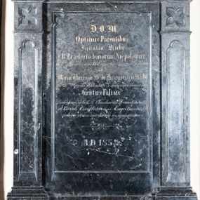 Zdjęcie nr 1: Epitafium osadzone na dwudzielnym, prostopadłościennym cokole, z prostokątną tablicą inskrypcyjną ujętą pilastrami o trzonach z prostokątnymi płycinami zamkniętymi trójlistnie i czworoliściami. Podpory dźwigają profilowany, wyłamany na ich osiach gzyms. Zwieńczenie zamknięte schodkowo, z tarczą z godłem herbu własnego rodziny Kube. Zwieńczenie ujmują pinakle, a wieńczy krzyż. W polu inskrypcja: "D(EO) O(PTIMO) M(AXIMO) / Optimis Parentibus / Ignatio Kube / C(esareo) R(egii) Praefecto bonorum Niepołomice / die 8vo Novembris anni 1832 aetatis 65 annorum defuncto / et / Mariae Theresae B(aronissae) de Kriegsriesen Kube / die 26 ma Aprilis 1853 aetate 75 annorum demortuae / Gratus Filius / Ludovicus Kube C(esareo) R(egii) Consularius Locumenentiae / et  Circuli Czortkoviensis Capitaneus / aureae crucis meritorum insignis posuere / + / A(NNO) D(OMINI)1858".