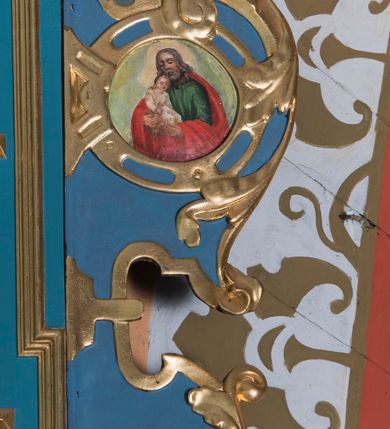 Zdjęcie nr 9: Ołtarz architektoniczny, jednokondygnacyjny, jednoosiowy ze zwieńczeniem. Ołtarz prostopadłościenny, o przednich narożach ujętych pilastrami hermowymi, z drewniana mensą. Antepedium w formie prostokątnej płyciny z płaskorzeźbionym medalionem z monogramem maryjnym okolonym drobnymi promieniami i ujętym liśćmi i kwiatami narcyza. Retabulum osadzone na niewysokim cokole, lekko zryzalitowanym po bokach. Wyżej predella ujęta parą konsoli wolutowych wspierających wyłamujący się ponad nimi gzyms. Cokół wraz z predellą flankowany parą uszaków w formie spływów wolutowych. Część środkowa ujęta parą kolumn o trzonach zdobionych motywem kandelabru, wspierających fryz wyłamujący się ponad nimi oraz gzyms przybierające postać trójboczną. Zwieńczenie w kształcie kwadratu zamkniętego odcinkiem gzymsu o lekko zryzalitowanych bokach. Predellę, część środkową i zwieńczenie ujmują pary ujmują pary uszaków o fantazyjnych wykrojach, zdobione ornamentem okuciowym i wicią roślinną. Uszaki zwieńczenia dodatkowo zdobione parą główek anielskich i medalionów ze św. Józefem po prawej stronie i św. Zofią po lewej. Na bokach gzymsu para figur siedzących aniołów. Szczyt w postaci ujętego parą wolut i zwieńczonego krzyżem kartusza z okrągłym  medalionem z monogramem maryjnym. w predelli obraz w kształcie leżącego prostokąta ze sceną Zwiastowania. Pole środkowe retabulum, ujęte motywami kaboszonów, ma kształt stojącego prostokąta zamkniętego półkolistym łukiem nadwieszonym, w środku obraz Madonny z Dzieciątkiem. W zwieńczeniu obraz w kształcie stojącego prostokąta, ujęty szeroką ramą z uszakami w narożach, zdobioną ornamentem. W środku wizerunek Matki Boskiej Różańcowej ze św. Dominikiem. Struktura polichromowana w odcieniach koloru niebieskiego, detal architektoniczny i ornamentyka złocone i srebrzone.      