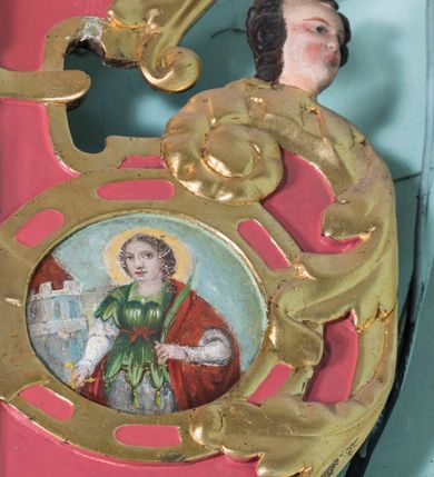 Zdjęcie nr 6: Ołtarz architektoniczny, jednokondygnacyjny, jednoosiowy ze zwieńczeniem. Ołtarz prostopadłościenny, o przednich narożach ujętych pilastrami hermowymi, z drewniana mensą. Antepedium w formie prostokątnej płyciny z płaskorzeźbionym motywem hostii okolonej drobnymi promieniami i ujętej liśćmi i pąkami mniszka lekarskiego.  Retabulum osadzone na niewysokim cokole, lekko zryzalitowanym po bokach. Wyżej predella ujęta parą konsoli wolutowych wspierających wyłamujący się ponad nimi gzyms. Cokół wraz z predellą flankowany parą uszaków w formie spływów wolutowych. Część środkowa ujęta parą kolumn o trzonach zdobionych motywem kandelabru, wspierających fryz wyłamujący się ponad nimi oraz gzyms przybierające postać trójboczną. Zwieńczenie w kształcie kwadratu zamkniętego odcinkiem gzymsu o lekko zryzalitowanych bokach. Predellę, część środkową i zwieńczenie ujmują pary ujmują pary uszaków o fantazyjnych wykrojach, zdobione ornamentem okuciowym i wicią roślinną. Uszaki zwieńczenia dodatkowo zdobione parą główek anielskich i medalionów ze św. Barbarą po prawej stronie i św. Katarzyną Aleksandryjską po lewej. Na bokach gzymsu para figur siedzących aniołów. Szczyt w postaci ujętego parą wolut i zwieńczonego krzyżem kartusza z okrągłym  medalionem z monogramem imienia Jezus. w predelli obraz w kształcie leżącego prostokąta ze sceną Nawiedzenie św. Elżbiety. Pole środkowe retabulum, ujęte motywami kaboszonów, ma kształt stojącego prostokąta zamkniętego półkolistym łukiem nadwieszonym, w środku obraz Najświętszego Serca Jezusa. W zwieńczeniu obraz w kształcie stojącego prostokąta, ujęty szeroką ramą z uszakami w narożach, zdobioną ornamentem. W środku wizerunek Matki Boskiej Różańcowej ze św. Teresą z Avila. Struktura polichromowana w odcieniach brązu, detal architektoniczny i ornamentyka złocone i srebrzone.      