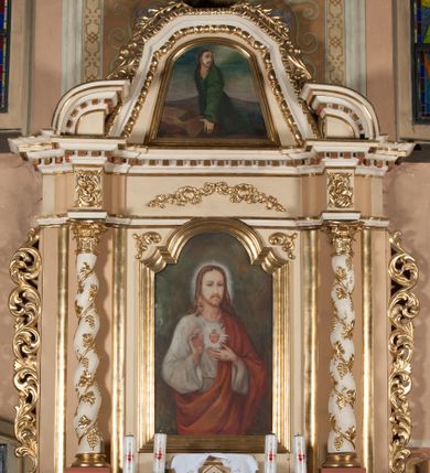 Zdjęcie nr 1: Nastawa architektoniczna, jednoosiowa, jednokondygnacyjna ze zwieńczeniem, ustawiona na dwustrefowym cokole. Ołtarz drewniany, prostopadłościenny z drewnianą mensą. Antepedium ujęte profilowaną ramą, w jego polu okrągły medalion z monogramem IHS. Na ołtarzu tabernakulum w formie drewnianej skrzynki, flankowanej z przodu dwiema kolumienkami dźwigającymi trójkątnie wyłamany łuk, drzwiczki w formie stojącego prostokąta zamkniętego półkoliście z płaskorzeźbionym przedstawieniem kielicha z hostią w glorii. Tabernakulum zakończone tronem wystawienia w formie cokołu. Retabulum ujęte parą zdwojonych pilastrów i stojącą przed nimi parą kolumn o skręconych trzonach oplecionych wicią i kapitelach kompozytowych. Podpory dźwigają pełne belkowanie, wyłamane na ich osi oraz przerwany półkolisty przyczółek, dekorowane w partii fryzu ornamentem roślinnym, a w partii gzymsu kostkowaniem. W polu głównym obraz Najświętszego Serca Jezusa w formie stojącego prostokąta zamkniętego łukiem półkolistym nadwieszonym z uskokiem ujęty profilowaną ramą. Kondygnacja flankowana uszami utworzonymi ze stylizowanych liści akantu. Zwieńczenie zbliżone do trapezu, zamkniętego łukiem odcinkowym, ujętym profilowaną ramą dekorowaną kimationem, po bokach flankowane stylizowanym ornamentem roślinnym. W polu obraz Chrystusa w Ogrójcu w zbliżonej do zwieńczenia formie, ujęty profilowaną ramą. Struktura polichromowana w kolorze beżowym, z białymi detalami, pozłacanym ornamentem i profilami.
