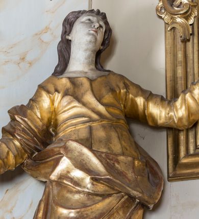 Zdjęcie nr 15: Nastawa ołtarzowa architektoniczna, jednoosiowa, jednokondygnacyjna ze zwieńczeniem, ustawiona na dwustrefowym cokole z wyodrębnionymi prostopadłościanami. Ołtarz kamienny, prostopadłościenny, w drewnianej obudowie. Mensa kamienna z marmurowym portatylem. Antepedium drewniane, w kształcie leżącego prostokąta, ujęte profilowaną ramą, z płaskorzeźbionym monogram IHS w glorii oraz fragmentami ornamentu roślinnego. Tabernakulum w formie prostopadłościennej skrzynki o wypukłym licu, flankowanej parą kolumienek na cokołach, ustawionych pod kątem, dźwigających woluty oraz gzyms przyjmujący formę łuku segmentowego nadwieszonego. Drzwiczki w kształcie stojącego prostokąta zamkniętego łukiem półkolistym, w opasce, z płaskorzeźbionym przedstawieniem baranka apokaliptycznego, leżącego na księdze, w glorii. Nastawa ujęta dwiema parami pilastrów dekorowanych rocaille'em i stojącą pomiędzy nimi parą kolumn o kapitelach kompozytowych dźwigających pełne belkowanie, wyłamane na ich osi, przerwane pośrodku. Na belkowaniu ustawione dwa wazony. W polu centralnym głęboka wnęka w formie stojącego prostokąta zamkniętego łukiem półkolistym nadwieszonym z uskokiem, ujęta profilowaną ramą, z obrazem św. Małgorzaty w osobnej profilowanej ramie o kształcie stojącego prostokąta zamkniętego ornamentalnym łukiem. Ponad nią, w partii belkowania rokokowy kartusz z rytą koroną i liśćmi palmy, a poniżej prostokątna płycina z wotami. Pole flankowane figurami św. Jana Ewangelisty i Matki Boskiej stojącymi na ćwierćkolistych cokołach. Nastawa ujęta uszami utworzonymi z rocaille'u. Zwieńczenie w formie stojącego prostokąta o wklęsłych bokach, ze spływami z uszakami po bokach, zamknięte gzymsem przyjmującym formę łuku segmentowego nadwieszonego z uskokiem, wyłamanego przy brzegach, dekorowanego rocaille'em. W polu obraz św. Małgorzaty ujęty profilowaną ramą w kształcie stojącego prostokąta zamkniętego łukiem segmentowym nadwieszonym z uskokiem. 
Struktura marmoryzowana w kolorze beżowym; ornamentyka, profile i kolumny złocone.