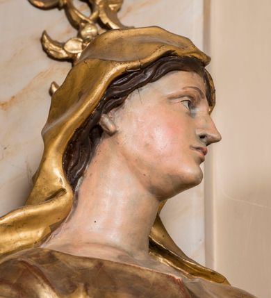 Zdjęcie nr 20: Nastawa ołtarzowa architektoniczna, jednoosiowa, jednokondygnacyjna ze zwieńczeniem, ustawiona na dwustrefowym cokole z wyodrębnionymi prostopadłościanami. Ołtarz kamienny, prostopadłościenny, w drewnianej obudowie. Mensa kamienna z marmurowym portatylem. Antepedium drewniane, w kształcie leżącego prostokąta, ujęte profilowaną ramą, z płaskorzeźbionym monogramem maryjnym oraz fragmentami ornamentu roślinnego. Tabernakulum w kształcie prostopadłościennej skrzynki o wypukłym licu, flankowanej parą kolumienek na cokołach, ustawionych pod kątem, dźwigających woluty oraz gzyms przyjmujący formę łuku segmentowego nadwieszonego. Drzwiczki w kształcie stojącego prostokąta zamkniętego łukiem półkolistym, w opasce, z płaskorzeźbionym przedstawieniem baranka apokaliptycznego, leżącego na księdze, w glorii. Nastawa ujęta dwiema parami pilastrów dekorowanych rocaille'em i stojącą pomiędzy nimi parą kolumn o kapitelach kompozytowych dźwigających pełne belkowanie, wyłamane na ich osi, przerwane pośrodku. Na belkowaniu ustawione dwa wazony. W polu centralnym głęboka wnęka w formie stojącego prostokąta zamkniętego łukiem półkolistym nadwieszonym z uskokiem, ujęta profilowaną ramą, z obrazem Matki Boskiej z Dzieciątkiem w osobnej profilowanej ramie o kształcie stojącego prostokąta zamkniętego ornamentalnym łukiem. Ponad nią, w partii belkowania rokokowy kartusz z rytym monogramem Marii, a poniżej prostokątna płycina z wotami. Pole flankowane dwiema figurami kobiet stojącymi na ćwierćkolistych cokołach. Nastawa ujęta uszami utworzonymi z rocaille'u. Zwieńczenie w formie stojącego prostokąta o wklęsłych bokach, ze spływami z uszakami po bokach, zamknięte gzymsem przyjmującym formę łuku segmentowego nadwieszonego z uskokiem, wyłamanego przy brzegach, dekorowanego rocaille'em. W polu obraz „Nauczanie Marii przez Joachima” ujęty profilowaną ramą w kształcie stojącego prostokąta zamkniętego łukiem segmentowym nadwieszonym z uskokiem. 
Struktura marmoryzowana w kolorze beżowym; ornamentyka, profile i kolumny złocone.