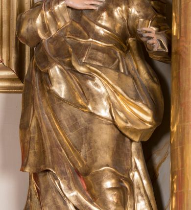 Zdjęcie nr 22: Nastawa ołtarzowa architektoniczna, jednoosiowa, jednokondygnacyjna ze zwieńczeniem, ustawiona na dwustrefowym cokole z wyodrębnionymi prostopadłościanami. Ołtarz kamienny, prostopadłościenny, w drewnianej obudowie. Mensa kamienna z marmurowym portatylem. Antepedium drewniane, w kształcie leżącego prostokąta, ujęte profilowaną ramą, z płaskorzeźbionym monogramem maryjnym oraz fragmentami ornamentu roślinnego. Tabernakulum w kształcie prostopadłościennej skrzynki o wypukłym licu, flankowanej parą kolumienek na cokołach, ustawionych pod kątem, dźwigających woluty oraz gzyms przyjmujący formę łuku segmentowego nadwieszonego. Drzwiczki w kształcie stojącego prostokąta zamkniętego łukiem półkolistym, w opasce, z płaskorzeźbionym przedstawieniem baranka apokaliptycznego, leżącego na księdze, w glorii. Nastawa ujęta dwiema parami pilastrów dekorowanych rocaille'em i stojącą pomiędzy nimi parą kolumn o kapitelach kompozytowych dźwigających pełne belkowanie, wyłamane na ich osi, przerwane pośrodku. Na belkowaniu ustawione dwa wazony. W polu centralnym głęboka wnęka w formie stojącego prostokąta zamkniętego łukiem półkolistym nadwieszonym z uskokiem, ujęta profilowaną ramą, z obrazem Matki Boskiej z Dzieciątkiem w osobnej profilowanej ramie o kształcie stojącego prostokąta zamkniętego ornamentalnym łukiem. Ponad nią, w partii belkowania rokokowy kartusz z rytym monogramem Marii, a poniżej prostokątna płycina z wotami. Pole flankowane dwiema figurami kobiet stojącymi na ćwierćkolistych cokołach. Nastawa ujęta uszami utworzonymi z rocaille'u. Zwieńczenie w formie stojącego prostokąta o wklęsłych bokach, ze spływami z uszakami po bokach, zamknięte gzymsem przyjmującym formę łuku segmentowego nadwieszonego z uskokiem, wyłamanego przy brzegach, dekorowanego rocaille'em. W polu obraz „Nauczanie Marii przez Joachima” ujęty profilowaną ramą w kształcie stojącego prostokąta zamkniętego łukiem segmentowym nadwieszonym z uskokiem. 
Struktura marmoryzowana w kolorze beżowym; ornamentyka, profile i kolumny złocone.