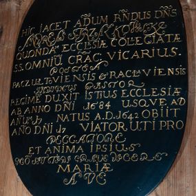 Zdjęcie nr 1: Płyta owalna, malowana na czarno. W polu łacińska inskrypcja, litery złocone: „D(EO) O(PTIMO) M(AXIMO) / HIC IACET AD(MOD)UM R(EVERE)NDUS D(OMI)N(U)S / ANDREAS STRZAŁKOWSKI / QUONDAM / ECCLESIAE COLLEGIATAE / S(ANCTORUM) OMNIU(M) CRAC(OVIAE) VICARIUS. / POSTEA / PACZUŁTOVIENSIS ET RACŁAVIENSIS / INDIGNUS PASTOR / REGIME(N) DUXIT ISTIUS ECCLESIAE / AB ANNO D(OMI)NI 1684 USQVE AD / AN(N)UM 17 [..] NATUS A(NNO) D(OMINI) 1642 OBIIT / AN(N)O D(OMI)NI 17 [...] VIATOR UTI PRO / PECCATORE / ET ANIMA IPSIUS / NO(N) SIT TIBI GRAVE DICERE / MARIAE / AVE".