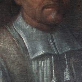 Zdjęcie nr 1: Obraz w kształcie medalionu, przedstawiający popiersie księdza Andrzeja Strzałkowskiego na czarnym tle. Ksiądz zwrócony w trzech czwartych w lewo, ubrany w komżę z koloratką oraz z przewieszoną przez szyję fioletową stułą. Twarz zwrócona delikatnie w lewo, okolona krótkim zarostem, nos pociągły, oczy ciemne ze wzrokiem skierowanym na wprost, wysokie czoło, gęste włosy o średniej długości. Rama drewniana, profilowana, malowana na czarno.
