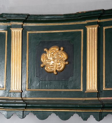 Zdjęcie nr 14: Chór muzyczny na zachodniej ścianie nawy, wsparty na dwóch słupach, ozdobionych od strony nawy dwoma kanelowanymi pilastrami o kapitelach kompozytowych. Jego parapet jest wklęsło-wypukły, z profilowanym cokołem, podzielony na kwatery kanelowanymi i złoconymi pilastrami. W kwaterach wypukłe pola kwadratowe o ćwierkolistych narożach ozdobione rzeźbionymi stylizowanymi rozetami. Parapet zwieńczony niewielkim gzymsem przełamanym na osi pilastrów. Pod listwą cokołu falisty fartuch. Struktura chóru muzycznego ciemnozielona. Pola płycin oliwkowo-ciemnozielone. Pilasty, rozety i profilowania są złocone. 
Znajdujący się na chórze prospekt wsparty na cokole z czterema kroksztynami, trzyosiowy, z osiami wydzielonymi kwadratowymi w podstawie filarkami. Oś środkowa podzielona na wie strefy: dolną z dwiema arkadkami z kostkowanym gzymsem i górną zamkniętą łukiem odcinkowym. Osie boczne zakończone gzymsem z kostkowaniem. W partii cokołowej bogato rzeźbiony motyw małżowinowo-chrząstkowy. 