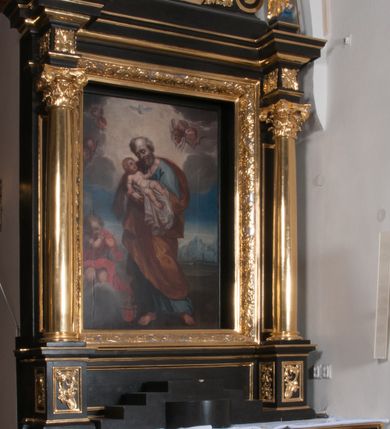 Zdjęcie nr 1: Nastawa ołtarzowa architektoniczna, jednoosiowa, jednokondygnacyjna, ze zwieńczeniem, flankowana kolumnami o kompozytowych kapitelach. Kolumny, umieszczone na prostokątnych postumentach, wspierają występujące nad podporami uproszczone belkowanie i gzyms. Pośrodku prostokątna nisza na obraz. Zwieńczenie flankowane spływami wolutowymi, z wazonami, zamknięte falistym, wklęsło-wypukłym gzymsem. Pośrodku ośmioboczna profilowana nisza na obraz. Po bokach zwieńczenia, w osiach kolumn, na postumentach rzeźby św. Wojciecha i św. Stanisława. Ołtarz zwieńczony rzeźbą św. Jakuba Starszego.Na fryzie i narożach zwieńczenia ornamenty roślinne. Mensa prostopadłościenna; antenpedium w profilowanej ramie, ozdobione ukośną kratką, z Gorejącym Sercem oplecionym cierniem pośrodku oraz rozetą wśród stylizowanych liści w narożach. Na ściankach bocznych po jednej prostokątnej płycinie. W polu środkowym nastawy obraz z przedstawieniem św. Józefa, w polu zwieńczenia obraz z przedstawieniem śś. Piotra i Pawła. Struktura ołtarza malowana na czarno; kolumny, detale architektoniczne i motywy ornamentalne złocone.
