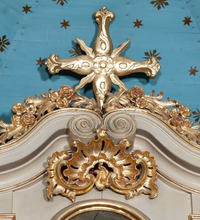 Zdjęcie nr 25: Ołtarz architektoniczny, jednoosiowy z bramkami, jednokondygnacyjny ze zwieńczeniem, na podwójnym cokole. Ołtarz murowany, licowany kamiennymi płytami, prostopadłościenny. Mensa betonowa. Antependium w formie wydłużonego, leżącego prostokąta, ujętego profilowaną ramą. Na srebrzonym polu płaskorzeźbiona, złocona dekoracja; w centrum rocaillowy kartusz ze sceną Zwiastowania Najświętszej Marii Panny, flankowany parą rocaillowych płycin, w których prawa z przedstawieniem mitry książęcej na poduszce ujętej różanymi gałązkami z gwiazdą, lewa z berłem na poduszce ujętym liliami zwieńczonej słońcem. 
Tabernaculum w formie prostopadłościennej szafki o wypukłej ścianie frontowej, z dwuskrzydłowymi drzwiczkami o kształcie zbliżonym do kwadratu, ujęte ramą; na łączeniu drzwiczek krzyż, flankowany przez odlewane kłosy zbóż i winne grono, całość na fakturowanym tle. Tabernaculum w drewnianej obudowie stanowiącej podstawę dla tronu wystawienia; cokół wyłamany, dekorowany płycinami z ornamentem roślinnym i campanullami; całość zamknięta gzymsem. Tron wystawienia w formie aediculi z obrotową niszą; ujęte parą półkolumn i parą kolumn o kapitelach kompozytowych i pseudokanelowanych trzonach dźwigających pełne belkowanie, wypukłe i wyłamane na kształt łuku odcinkowego nad niszą, wyłamane na osiach podpór. Nisza ujęta opaską dekorowaną akantem. W partii fryzu rozety i dekoracja roślinna. Całość zwieńczona postumentem  z leżącym na księdze barankiem. Tron flankują dwie figurki, adorujących aniołków, klęczących na cokole.
Nastawa ołtarzowa ujęta trzema parami pilastrów i parą skrajnych filarów o kapitelach kompozytowych i kanelowanych trzonach; oraz stojących przed nimi w dwóch strefach dwiema parami kolumn o kapitelach kompozytowych. Podpory dźwigają pełne belkowanie, wyłamane na ich osi; nad polem środkowym architraw przyjmuje kształt łuku nadwieszonego. Belkowanie oraz cokoły kolumn ustawione delikatnie pod katem względem lica retabulum. Na belkowaniu, na osi skrajnych kolumn przerwany, wolutowy przyczółek z siedzącą parą puttów. W polu środkowym  nisza w formie stojącego prostokąta zamkniętego łukiem nadwieszonym, z wklęsłymi dolnymi narożami i dolnym bokiem; ujęta profilowaną ramą; w polu płaskorzeźbiona scena z Widzeniem św. Franciszka. Zwieńczenie w formie stojącego prostokąta ujętego lizenami oraz spływami wolutowymi; zamknięte gzymsem przechodzącym w dwie zwrócone antytetycznie woluty. W polu obraz w formie stojącego owalu w profilowanej ramie z przedstawieniem św. Michała Archanioła. Retabulum ujęte bramkami z przejściami w formie stojącego prostokąta zamkniętego łukiem nadwieszonym z uskokiem, z drzwiczkami; zwieńczone podtrzymywanym przez konsolę cokołem dla figur aniołów, flankowanym spływami wolutowymi.
Cokoły dla kolumn dekorowane z trzech stron płycinami. Rama obrazu pola środkowego zdobiona na bokach rocaille z kwiatami i palmami; łuk zwieńczony rocaillowym kartuszem, flankowanym przez dwie palmy. Na gzymsie nad polem środkowym muszla. Lizeny i woluty zwieńczenia dekorowane campanullami; obraz u spodu i u góry ujęty rocaille. Na gzymsie wieńczącym dwa kwiatowe festony; na jego skraju para wazonów, całość zwieńczona stylizowanym rokokowym krzyżem.
Struktura polichromowana w kolorze kremowym, z detalami w kolorach szarym i brudnym różem; trzony kolumn marmoryzowane; ornamentyka i profile złocone.