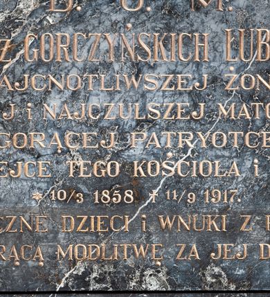 Zdjęcie nr 1: Epitafium w formie leżącego prostokąta, ujęte grubą ramą, dekorowaną po wewnętrznej stronie maswerkiem. W polu inskrypcja „D(EO) O(PTIMO) M(AXIMO) / ROZALII z GORCZYŃSKICH ŁUBIEŃSKIEJ / NAJCNOTLIWSZEJ ŻONIE, / NAJLEPSZEJ i NAJCZULSZEJ MATCE i BABCE, / GORĄCEJ PATRYOTCE, / DOBRODZIEJCE TEGO KOŚCIOŁA i LUDNOŚCI, / *10/3 1858 +11/9 1917. / WDZIĘCZNE DZIECI i WNUKI Z PROŚBĄ / O GORĄCĄ MODLITWĘ ZA JEJ DUSZĘ.”