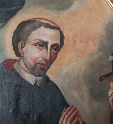 Zdjęcie nr 2: Obraz w kształcie stojącego owalu z wizerunkiem św. Stanisława Kazimierczyka. Bliżej lewej krawędzi płótna została ukazana do pasa postać Stanisława, który ma ręce złożone do modlitwy, a wzrok kieruje ku górze. Ma trójkątną twarz o dużych, głęboko osadzonych oczach, wąskim nosie i szerokich, lekko rozchylonych ustach. Po policzkach spływają mu łzy. Krótkie włosy ma zaczesane na boki, a na głowie wyciętą tonsurę. Jest ubrany w biały habit i podbitą czerwienią czarną pelerynkę z kapturem. Przed nim, na pokrytym czerwoną tkaniną blacie leży otwarta księga, ludzka czaszka i krucyfiks. Za świętym widoczny fragment granatowej kotary ze zwisającym chwostem. Tło obrazu  niejednolite – za głową Stanisława i na linii jego wzroku jasnożółte, w pozostałych miejscach niebieskoszare. Obraz oprawiono w profilowaną, złoconą ramę dekorowaną od góry ornamentem rocaille’owym, a od dołu zwiniętymi od wewnątrz w woluty liśćmi. 