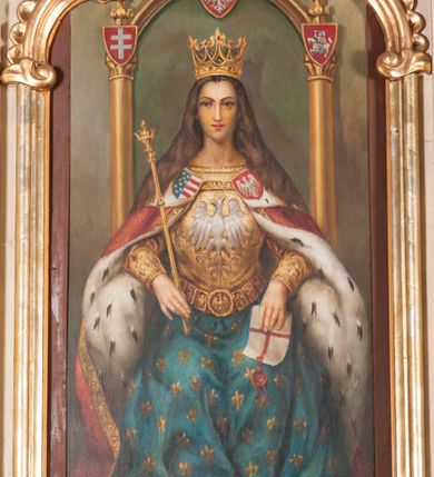 Zdjęcie nr 2: Ołtarz architektoniczny, przyścienny, jednokondygnacyjny, jednoosiowy ze zwieńczeniem. Mensa drewniana prostopadłościenna, przesłonięta prostokątnym antepedium wypełnionym tkaniną. Nastawa ustawiona na wysokim cokole ujęta pilastrami oraz stojącymi na ich tle gładkimi kolumnami kompozytowymi, podtrzymującymi odcinki rozbudowanego, częściowo ażurowego belkowania oraz fragmenty przyczółków, na których posadowiono złote aniołki o srebrnych skrzydłach. Pilastry dekorowane wicią akantową z rocaille’ami i palmetami schodzącymi do ustawionych poniżej relikwiarzy. W osi środkowej, w partii cokołu obraz Matki Boskiej Chęstochowskiej w złoto-srebrnej sukience, w prostokątnej, profilowanej, dekorowanej ramie. Powyżej obraz z wizerunkiem tronującej św. Jadwigi królowej Polski ujęty ramą w kształcie stojącego prostokąta zamkniętego od góry łukiem wklęsło-wypukłym. Powyżej dwie symetryczne plakiety ornamentalne ujmujące rozetkę. W zwieńczeniu zamkniętym łukiem nadwieszonym dekorowanym pąkami kwiatów gloria promienista z gładkim, okrągłym polem centralnym otoczonym obłokami. 
Całość struktury ołtarza polichromowana na kolor kremowy wnętrza płycin ciemniejsze, detal architektoniczny i ornamenty pozłacane i posrebrzane. 