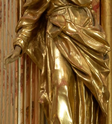 Zdjęcie nr 6: Retabulum architektoniczne, jednoosiowe, jednokondygnacyjne, ze zwieńczeniem,  posadowione na wysokim cokole. Nastawa ujęta ukośnie ustawionymi połówkami filarów na tle pilastrów, o kapitelach kompozytowych, podtrzymujących wydatne, przełamujące się nad nimi belkowanie z impostami i zwróconymi ku przodowi naczółkami, na których uskrzydlone, nagie putta, przepasane tkaninami. Zwieńczenie o lekko wklęsłych bokach zakończone gzymsem w formie łuku nadwieszonego. W partii fryzu kartusz ujęty wolutami, z lambrekinem u dołu, z muszlą palmetową u góry. W zwieńczeniu Oko Opatrzności na tle obłoków i promienistej glorii oraz dwie uskrzydlone główki anielskie. Dekorację ornamentalną tworzą kratki regencyjne, kampanule i muszle palmetowe. W części środkowej, we wnęce prostokątnej zamkniętej łukiem nadwieszonym półkolistym, w profilowanym obramieniu obraz Św. Katarzyna w profilowanej, prostokątnej ramie, nad nią rozłożysta palmeta. Wnęka ujęta kampanulami i gałązkami palmowymi. Po bokach nastawy dwie niezidentyfikowane postacie mężczyzn, całopostaciowe, w długich, silnie drapowanych sukniach, o wyrazistych twarzach, z krótkim zarostem i lekko falującymi włosami. Polichromia imitująca marmoryzację w odcieniach jasnych brązów, czerwieni i zieleni, figury o naturalnych karnacjach, złocenia szat figur i ornamentów, srebrzenia drobnych detali ornamentalnych.      
     
