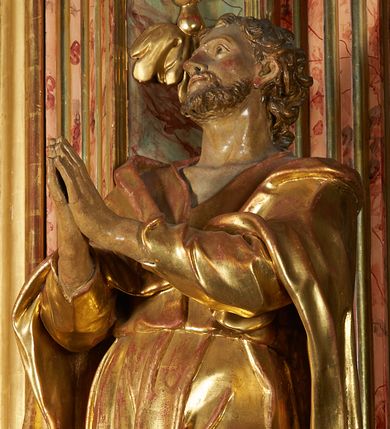 Zdjęcie nr 1: Święty został ukazany w całej postaci, ze złożonymi dłońmi w geście modlitewnym. Ciężar ciała oparty na prawej nodze, lewa nieco wysunięta. Głowa zwrócona w prawo ku górze. Broda krótka, włosy kręcone. Płaszcz i tunika bogato drapowane i złocone.