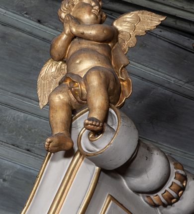 Zdjęcie nr 30: Ołtarz architektoniczny, jednoosiowy, jednokondygnacyjny, ze zwieńczeniem i bramkami bocznymi. Nastawa ujęta czworobocznymi kanelowanymi filarami umieszczonymi na tle kanelowanych pilastrów. Filary dźwigają pełne belkowanie i profilowany gzyms, występujące nad podporami, przerwane nad częścią środkową. Przy filarach rzeźby: po lewej Św. Piotr, po prawej Św. Paweł. W polu środkowym nastawy nisza w kształcie stojącego prostokąta zamkniętego łukiem półkolistym nadwieszonym, w profilowanej złoconej ramie. W niszy obraz z przedstawieniem św. Jakub Apostoła. Zwieńczenie w formie aedikuli zamkniętej łukiem półkolistym nadwieszonym, ujętej spływami wolutowymi. Pośrodku obraz w kształcie stojącego prostokąta, w ozdobnej ramie, z przedstawieniem św. Tekli w półpostaci. W osiach filarów odcinki przerwanego przyczółka, na których rzeźby siedzących puttów. Po bokach retabulum bramki z prześwitami w kształcie prostokąta zamkniętego łukiem kotarowym ściętym, w których osadzone płycinowe drzwi. Ponad bramkami konsole ujęte wolutami, na których rzeźby: po lewej Św. Wojciech, po prawej Św. Stanisław Biskup z Piotrowinem. W przyłuczach obrazu środkowego i we fryzie nałożone rzeźbione motywy rocaille’ów. Struktura nastawy w kolorze kremowym, ramy obrazów, kanelury, motywy ornamentalne złocone. 