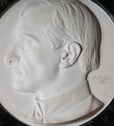 Zdjęcie nr 3: Epitafium w kształcie leżącego prostokąta z profilowanym obramieniem z uszakami. Na osi w górnej części owalny medalion z profilem zmarłego. Pośrodku tablicy inskrypcja: "Pamięci KS(KSIĘDZA) ZYGMUNTA GOLIANA / NIEZRÓWNANYCH CNÓT MĘŻA KAPŁANA, OBYWATELA / *1824_ +1885. / OJCU PARAFII – ODNOWICIELOWI KOŚCIOŁA – / OZDOBIE KAZALNICY – OPIEKUNOWI BIEDNYCH – / W DOWÓD NAJGŁĘBSZEJ CZCI I ŻALU / PARAFIANIE". W prawym dolnym rogu sygnatura kamieniarza: "E(DWARD) STEHLIK". W dolnej części medalionu sygnatura: "M(arceli) Guyski / 1886". 