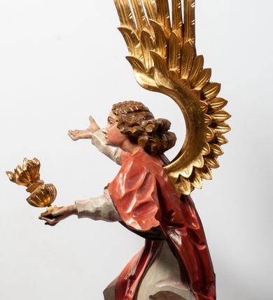 Zdjęcie nr 9: Tabernakulum proste, w formie prostopadłościennej skrzynki, o złotych drzwiczkach z wytłaczaną formą równoramiennego krzyża i wypukłą srebrną rybą oraz koszem z chlebem pośrodku. Po obu stronach, na niewysokich postumentach umieszczone dwa klęczące anioły z wysokimi, uniesionymi do góry skrzydłami, zwróconymi ku środkowi. Twarze o delikatnych rysach, silnie zarumienionych policzkach z 
długimi nosami, głęboko osadzonymi oczami i wysuniętym podbródkiem. Włosy długie, bujne, skręcone w duże pukle po bokach głowy. Anioły ubrane są w białe suknie i czerwone dalmatyki o fioletowych podszewkach. Anioł po lewej stronie trzyma w dłoniach kadzielnicę, a anioł po prawej płomienisty wazon. Polichromie w odsłoniętych partiach ciała naturalistyczne. 



