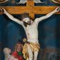 Zdjęcie nr 1: Krucyfiks w typie Cristo morte; postać  Chrystusa umarłego przybitego do krzyża trzema gwoździami. Sylwetka w delikatnym zwisie, o silnie zaznaczonej anatomii ciała, z podkreśloną linią żeber i zaznaczonymi śladami męki. Perizonium w formie tkaniny przewiązanej na sznurze na prawym boku, sięgające kolan i odsłaniające prawe udo. Twarz Jezusa podłużna opadająca na prawe ramię, okolona zarostem; oczy zamknięte, nos podłużny, usta delikatnie otwarte; włosy długie spływające na prawe ramię, na głowie zielona korona cierniowa. Krzyż drewniany, prosty. Nad głową Chrystusa zawieszona tabliczka w kształcie kartusza zdobionego ornamentem okuciowym z napisem „I.N.R.I.” Partie ciała polichromowane naturalistycznie, perizonium złocone.




